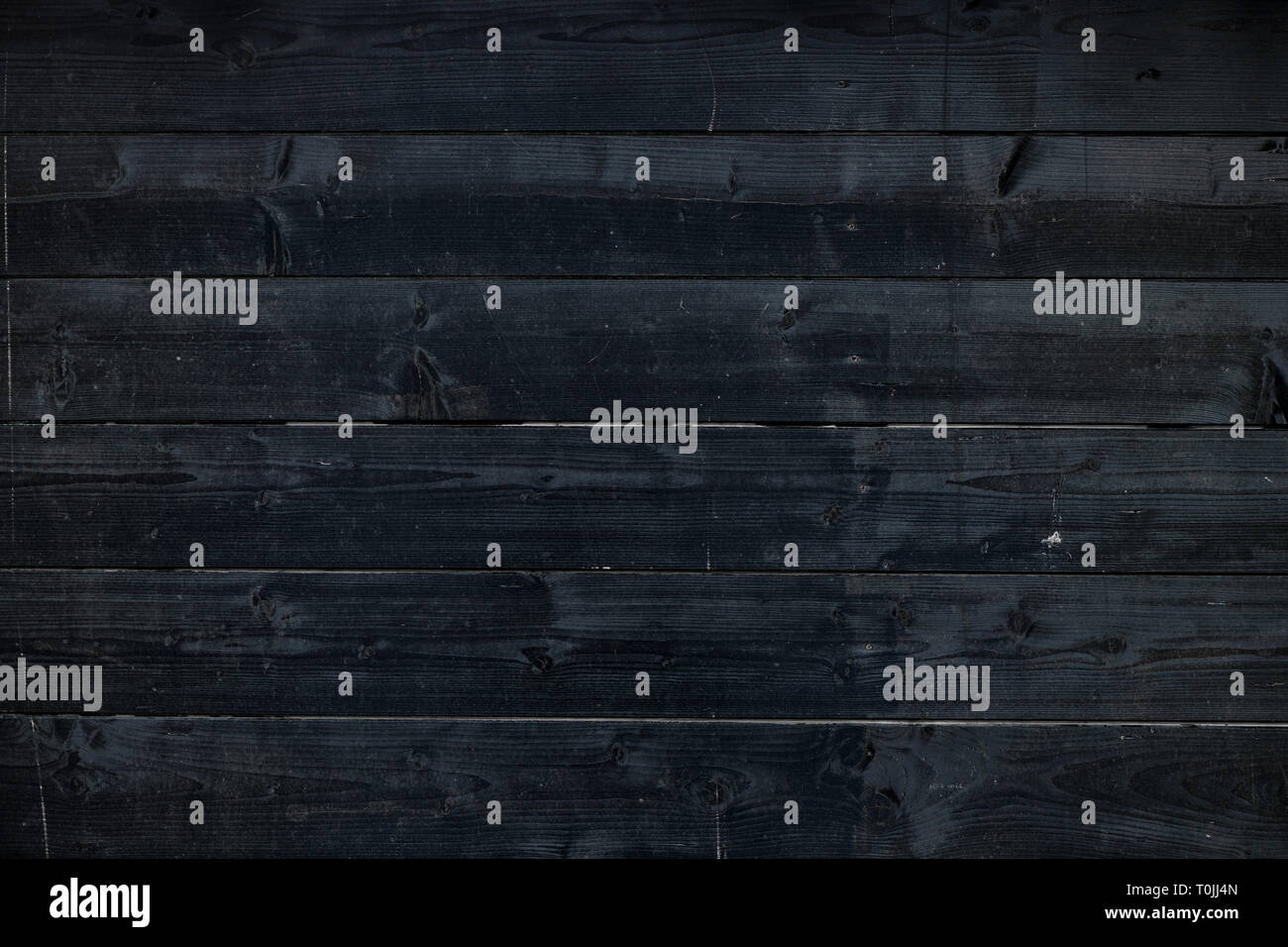 Nero scuro listoni in legno come sfondo. Texture di rustici e vecchi pannelli di legno dal di sopra. Foto Stock
