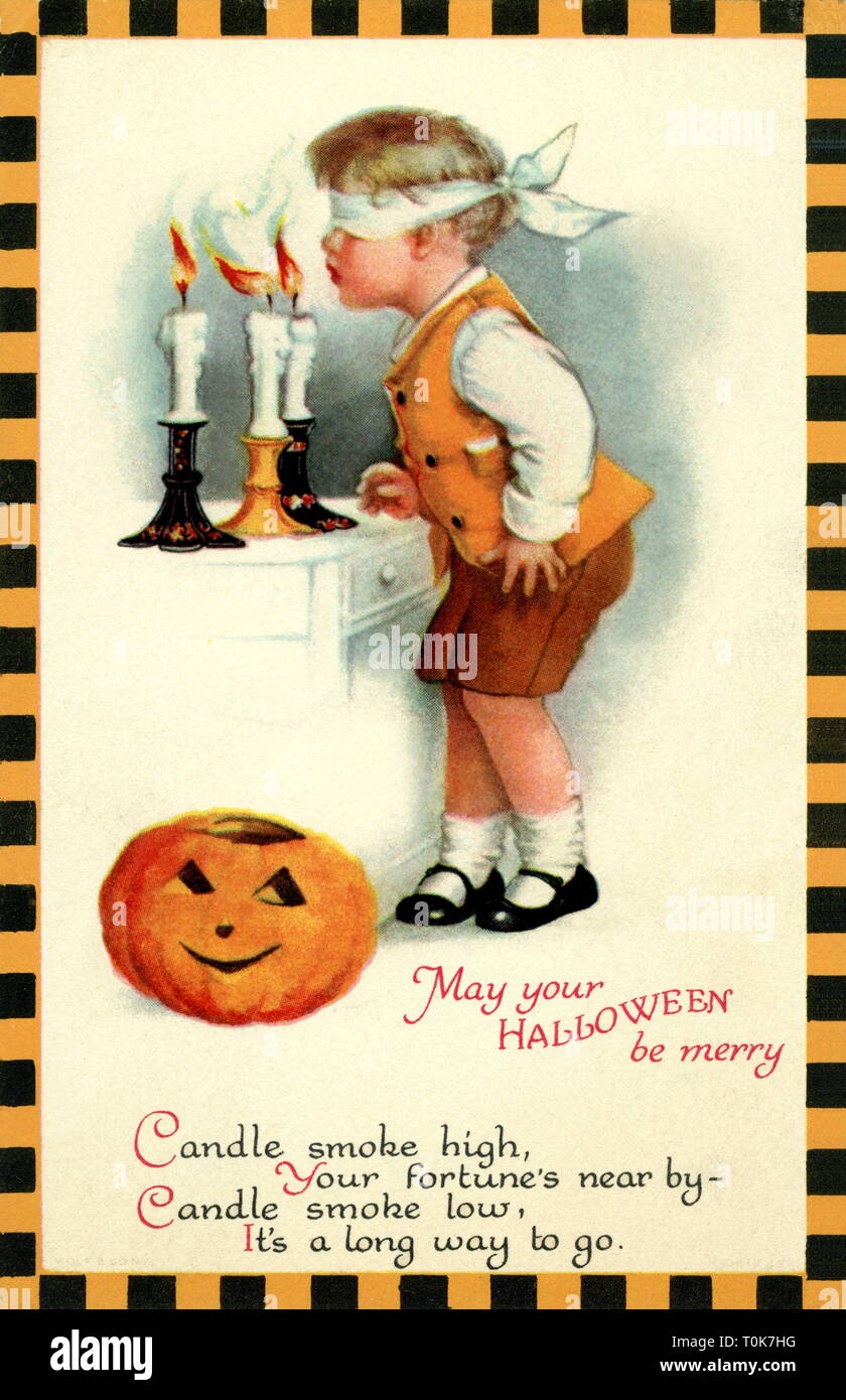 Festa di Halloween, ragazzo con gli occhi bendati soffiando fuori le candele, a seconda di come il fumo delle candele è di soffiaggio, otterrà presto lucky o non, cartolina, USA, circa 1927, Additional-Rights-Clearance-Info-Not-Available Foto Stock