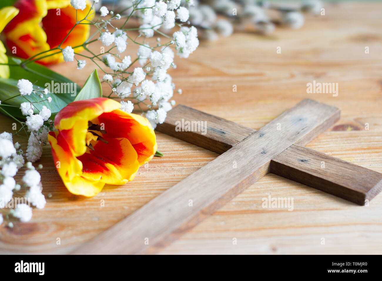 Molla di fiori di pasqua e la croce su sfondo di legno Foto Stock