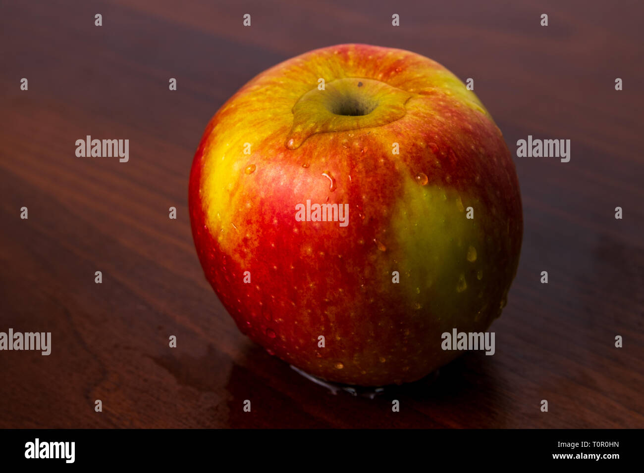 Sana apple organico isolato su un legno scuro dello sfondo Foto Stock