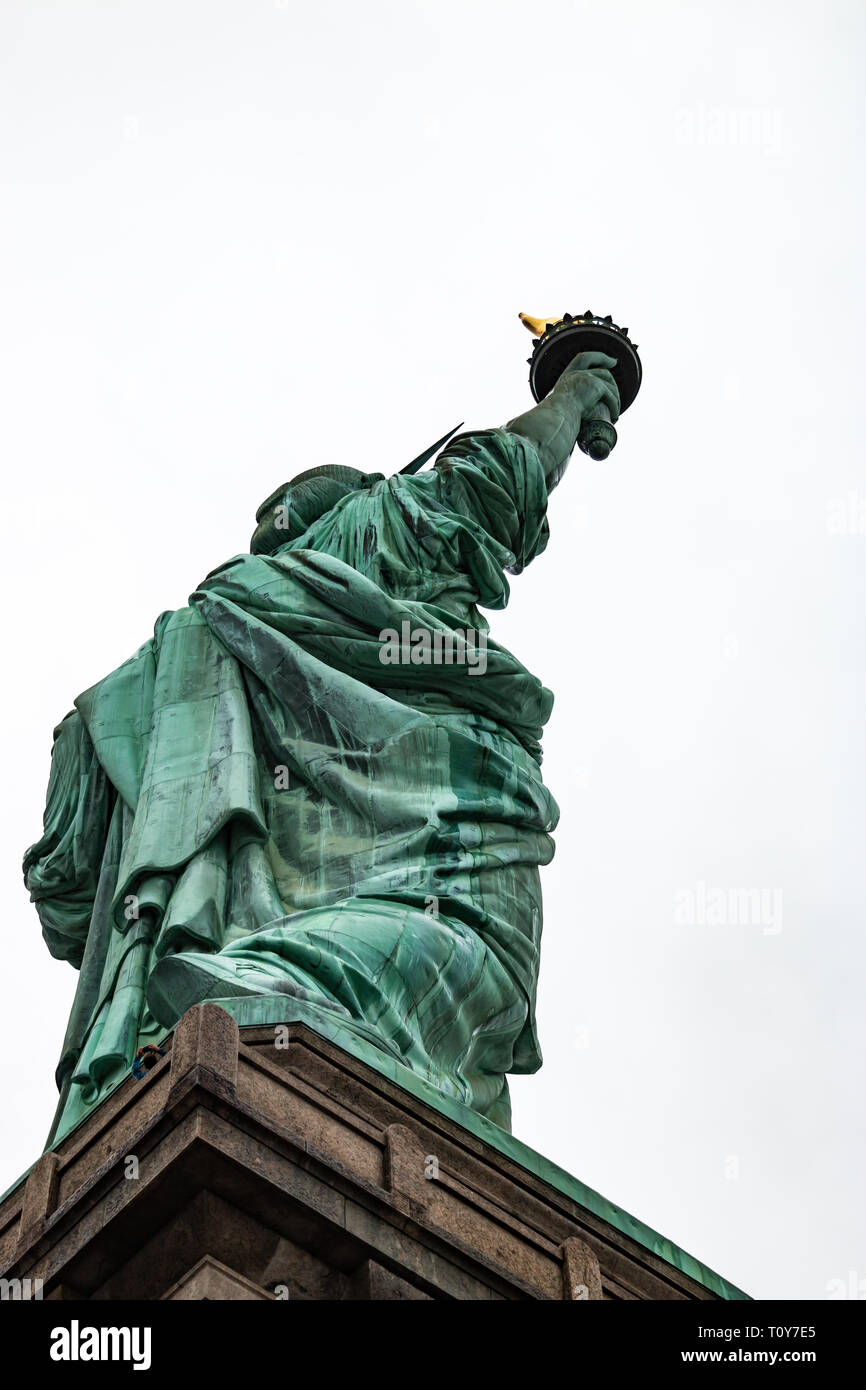 Una vista da dietro che mostra la Statua della Libertà sotto la pioggia ma essere orgogliosi. Foto Stock