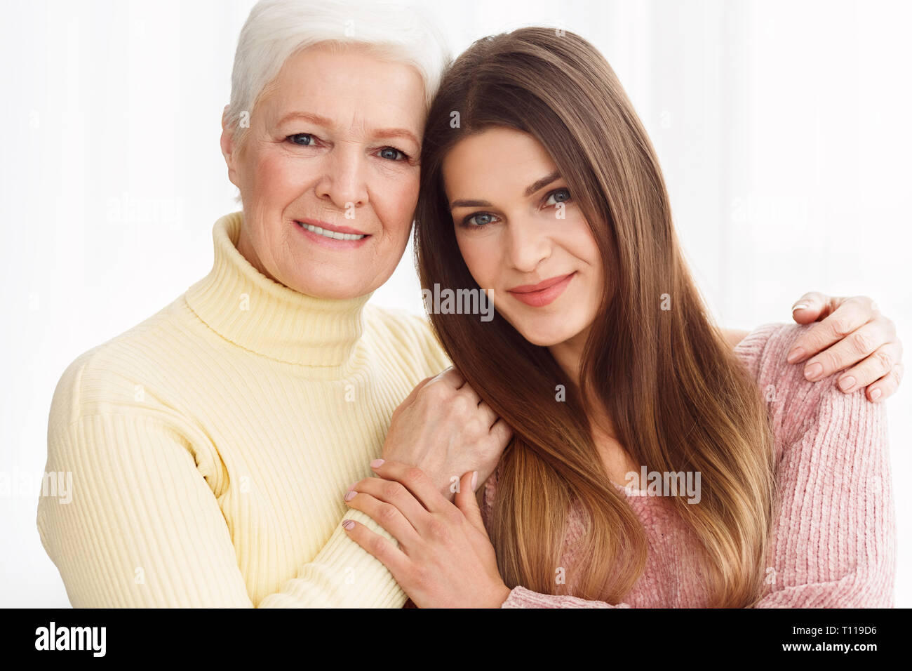 Due generazioni. Coppia madre e figlia avvolgente Foto Stock