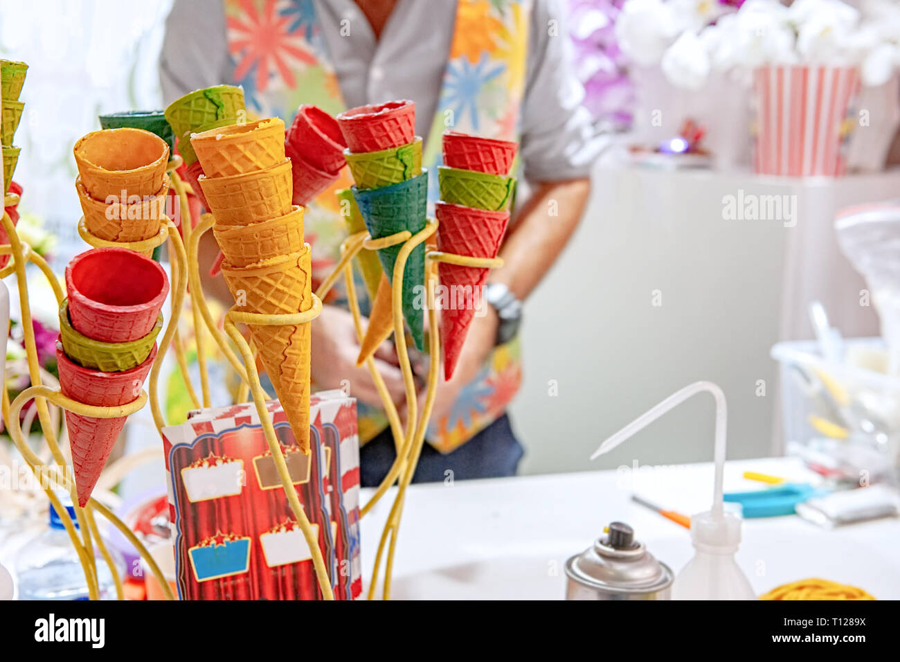Svuotare i coni di cialda con vintage waffle ferro sul tavolo. Uso non convenzionale di cialda tazze in floristics. Foto Stock