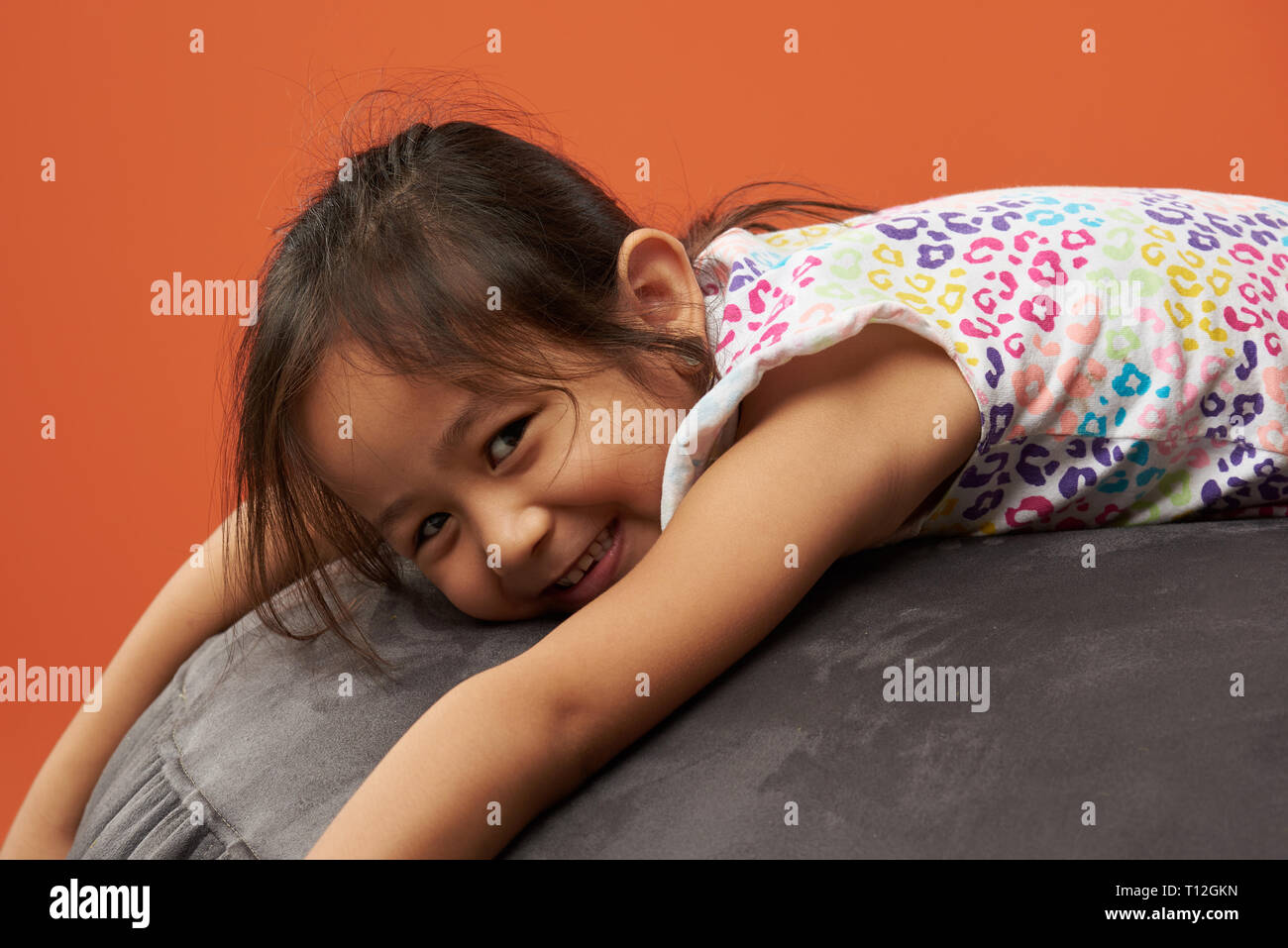 Asian kid relax su una beanbag. Filipina kid. Foto Stock