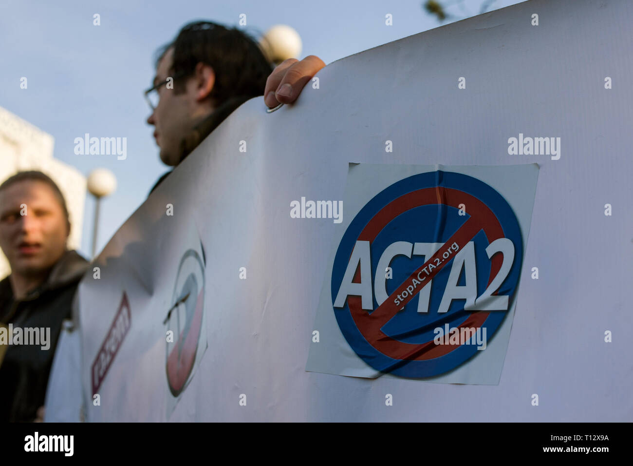 Un uomo è visto tenendo un banner con un anti Acta 2 adesivo sul durante la protesta. Il voto sulla modifica del diritto d'autore nella Unione europea avrà luogo negli ultimi giorni del mese di marzo. Pertanto, il 23 marzo, gli oppositori del controverso gli articoli 11 e 13 intendono mobilitare e prendere per le strade. L'arresto internazionale Acta 2.0 le azioni di protesta hanno avuto luogo anche a Varsavia e altre numerose città della Polonia. Foto Stock