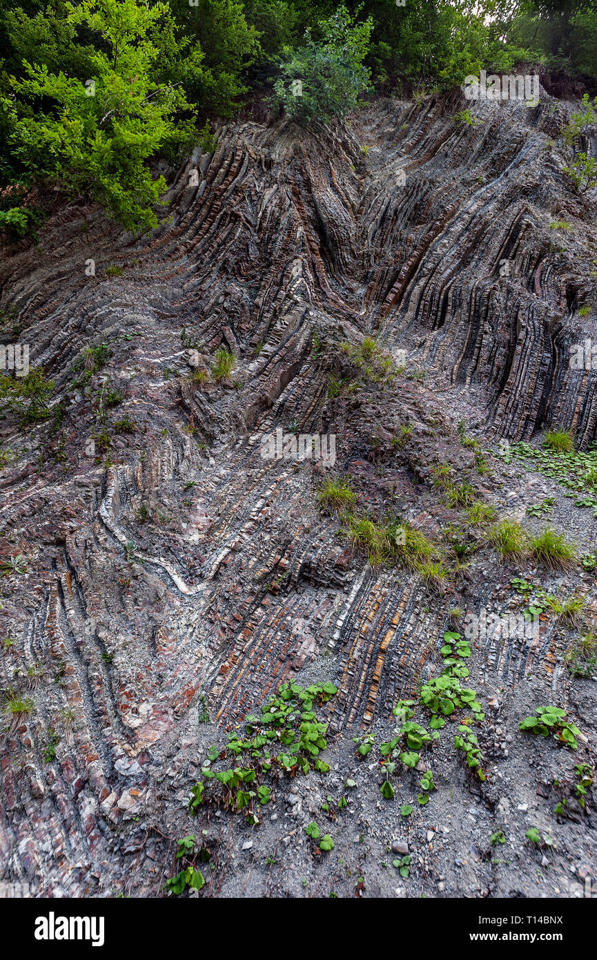 Russia, Regione Krasnodar, la strada a Sochi. La bizzarra geometria dei monti del Caucaso. Multi-colore di strati di calcare in ardesia. Foto Stock