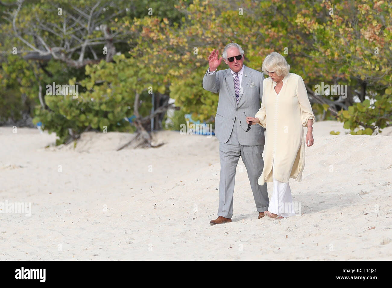 Il Principe di Galles e la duchessa di Cornovaglia a piedi lungo il Grand Anse Beach durante un giorno di visita all'isola caraibica di Grenada. Foto Stock