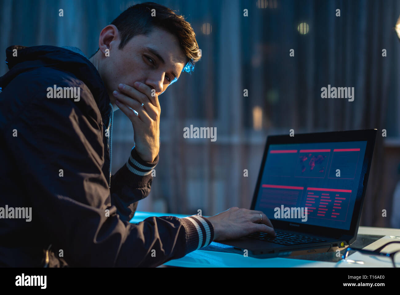 Uomo che guarda nella telecamera. Attacchi di hacker e il furto di accedere ai database con password. Il concetto di cyber security Foto Stock