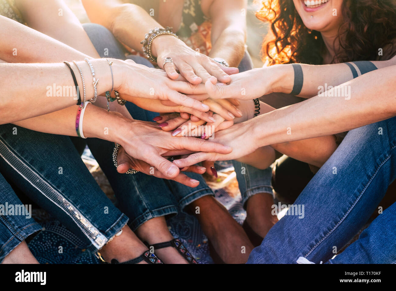 La felicità e allegro stile di vita per il team concetto ragazze mettendo le mani insieme ad amici per sempre - la felicità e amicizia gruppo di donne sorriso e Foto Stock