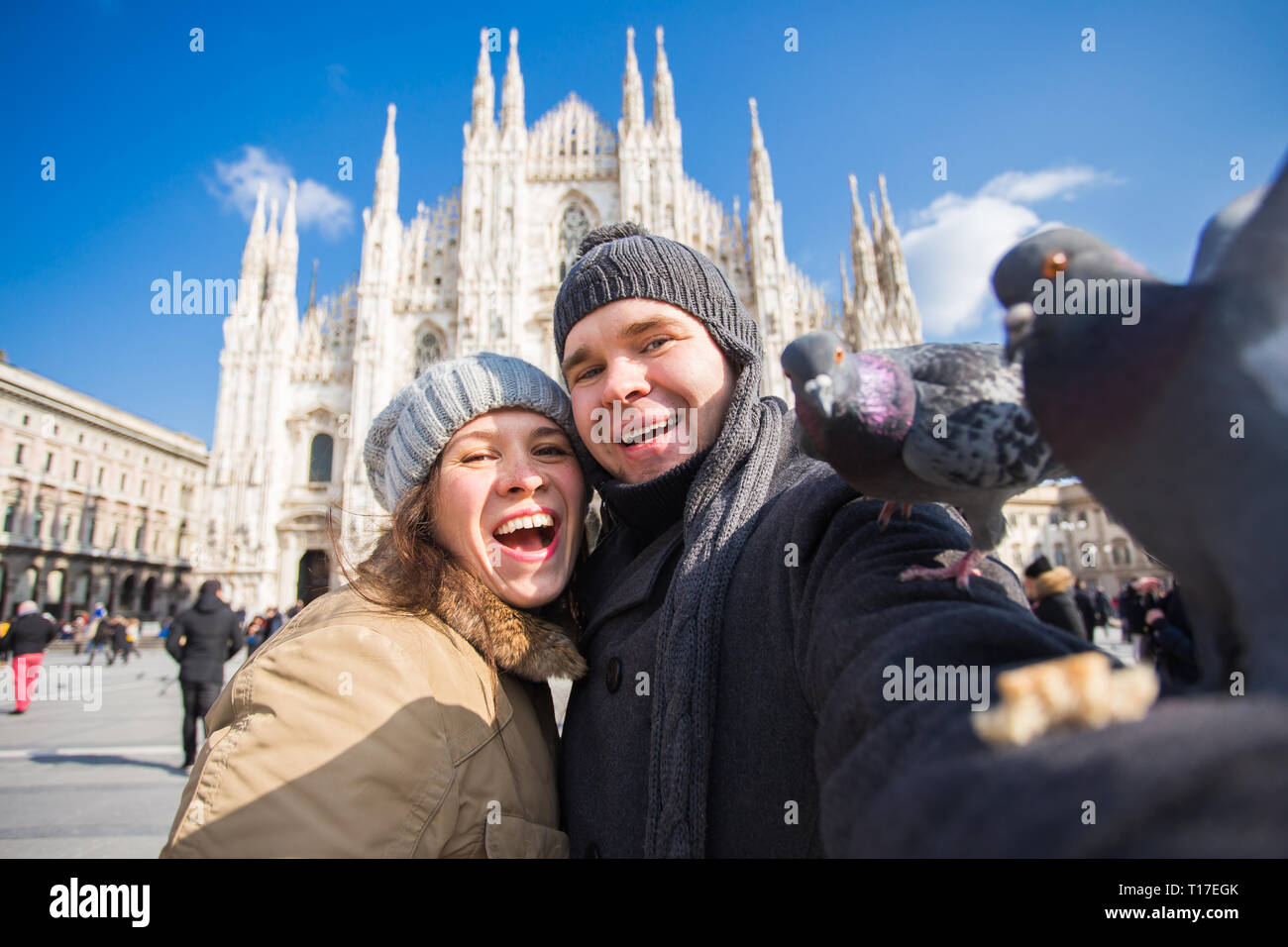 Viaggi, Italia e divertente giovane concetto - Happy turisti prendendo un autoritratto con piccioni nella parte anteriore del Duomo di Milano Foto Stock