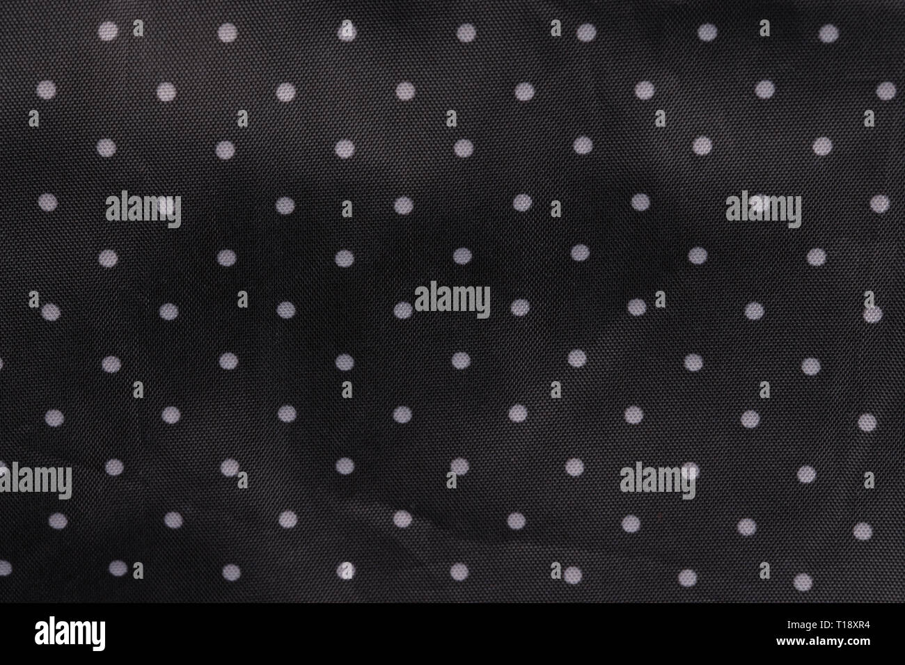 Tessuto nero lo sfondo con puntini bianchi Foto Stock