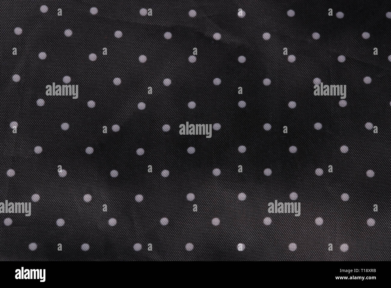 Tessuto nero lo sfondo con puntini bianchi Foto Stock