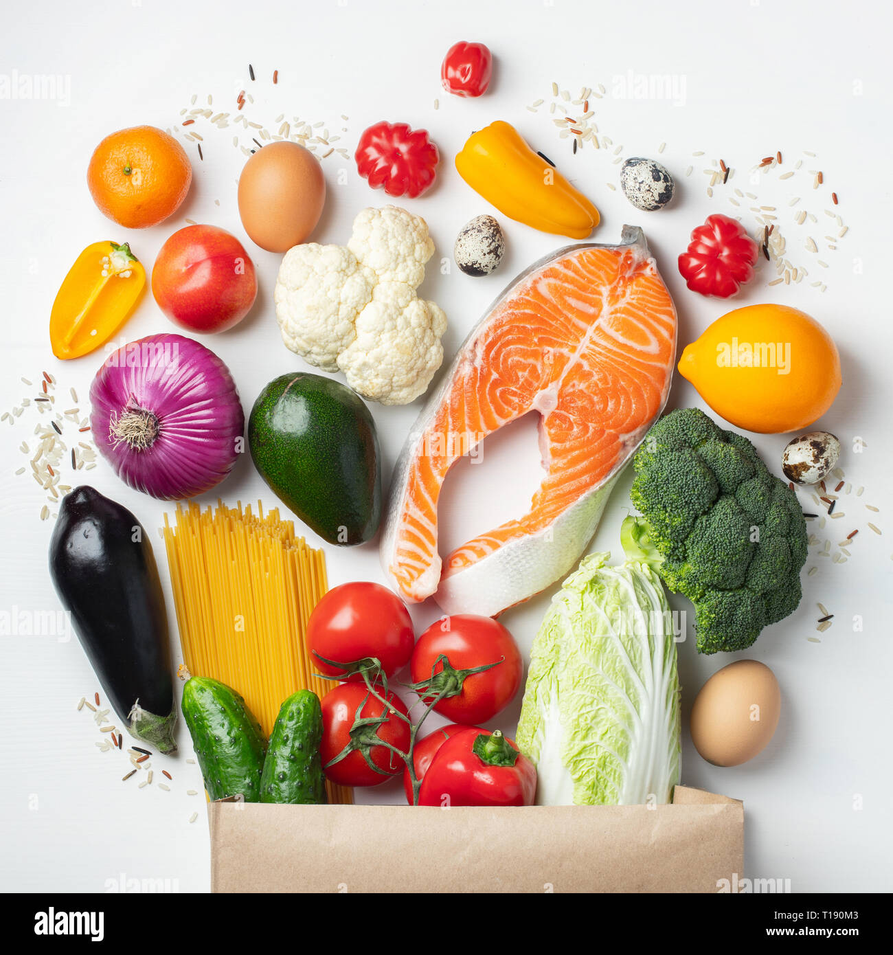 Supermercato. Sacchetto di carta pieno di cibo sano su uno sfondo bianco. Vista dall'alto. Lay piatto. Foto Stock