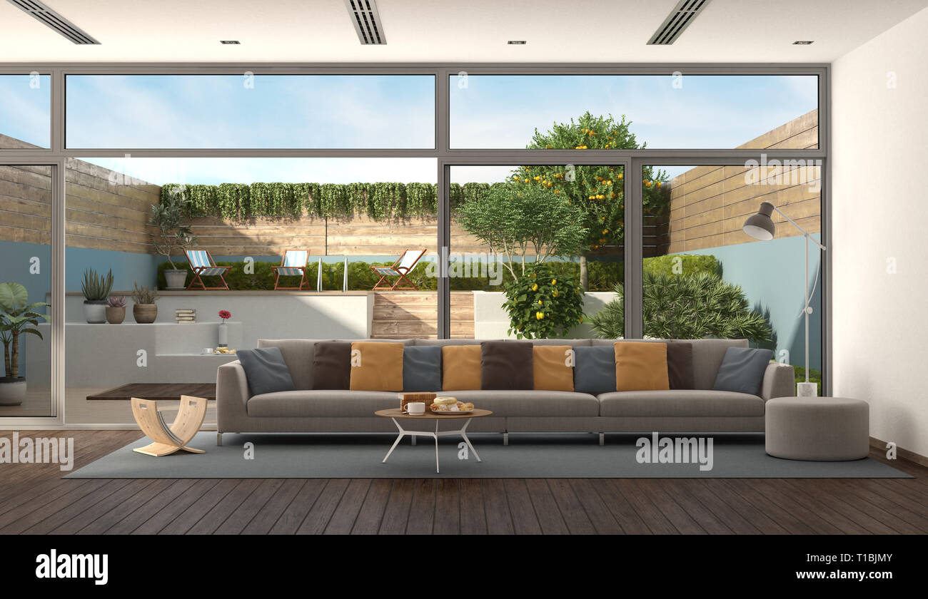 Soggiorno di una villa moderna con divani colorati e giardino in background - 3d rendering Foto Stock