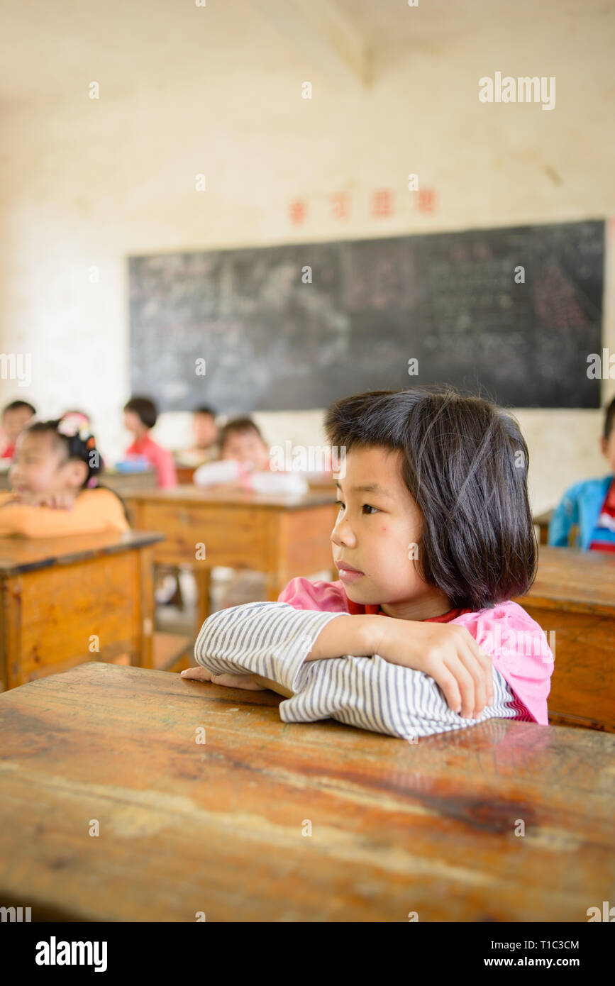 Elementare scuola di età i bambini che frequentano la classe in una classe rurale nella regione di Guangxi del centro sud della Cina. Foto Stock