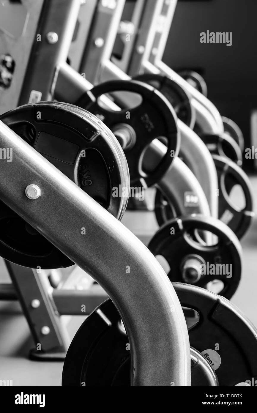 Una moderna palestra interno con pressa da banco attrezzature in un raw Foto Stock