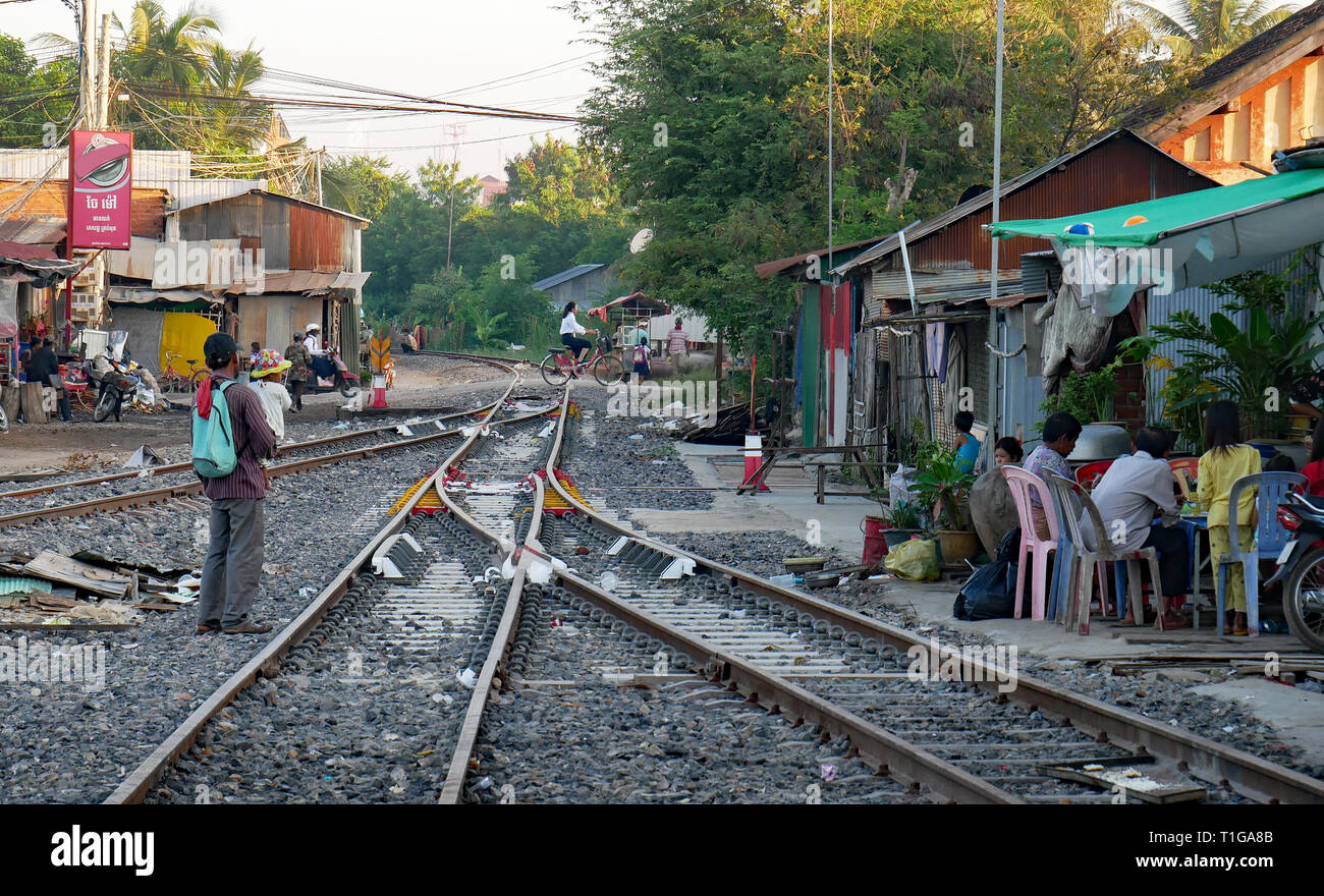Le persone che vivono accanto a una linea ferroviaria. La vita di famiglia si passa accanto a una lettiera disseminata ferrovia via nei pressi di Battambang, Cambogia, stazione ferroviaria. Dic 2018 Foto Stock