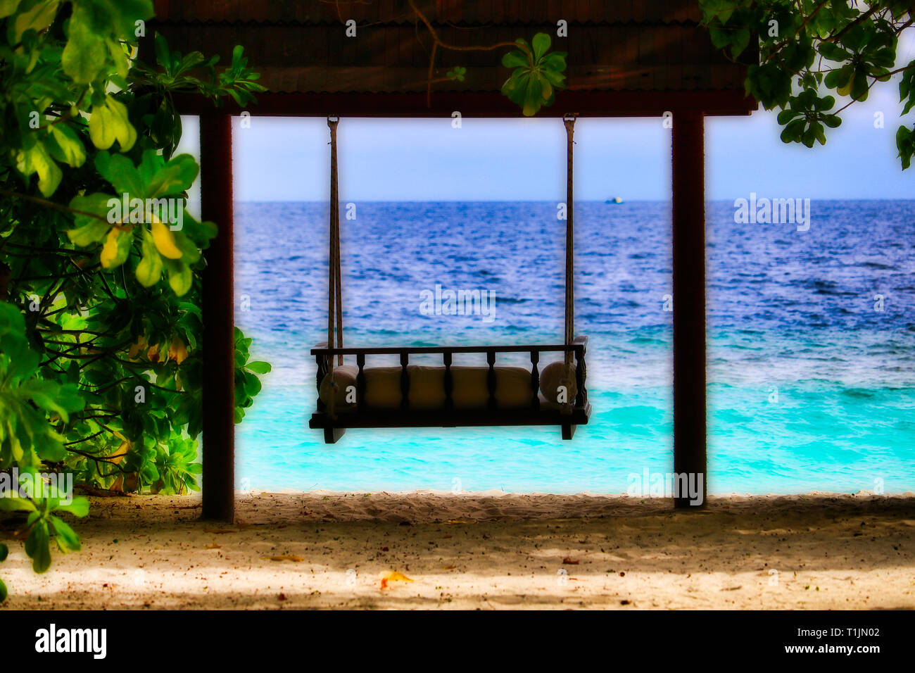 Questa unica immagine mostra una splendida e romantica swing partner! A destra e a sinistra delle piante tropicali e con vista sul mare Foto Stock Questa unica immagine mostra una splendida e romantica swing partner! A destra e a sinistra delle piante tropicali e con vista sul mare Foto Stock