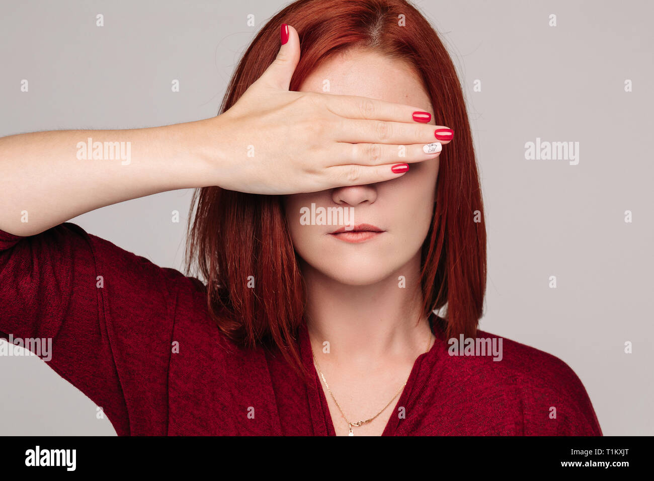 Chiusa fino piuttosto dai capelli rossi la donna a bordo blusa con mal di testa. Foto Stock