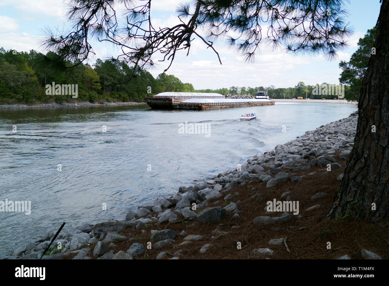 Rimorchiatore spinge una chiatta verso ovest sulla Intracoastal Waterway attraverso Orange Beach, Alabama. Foto Stock