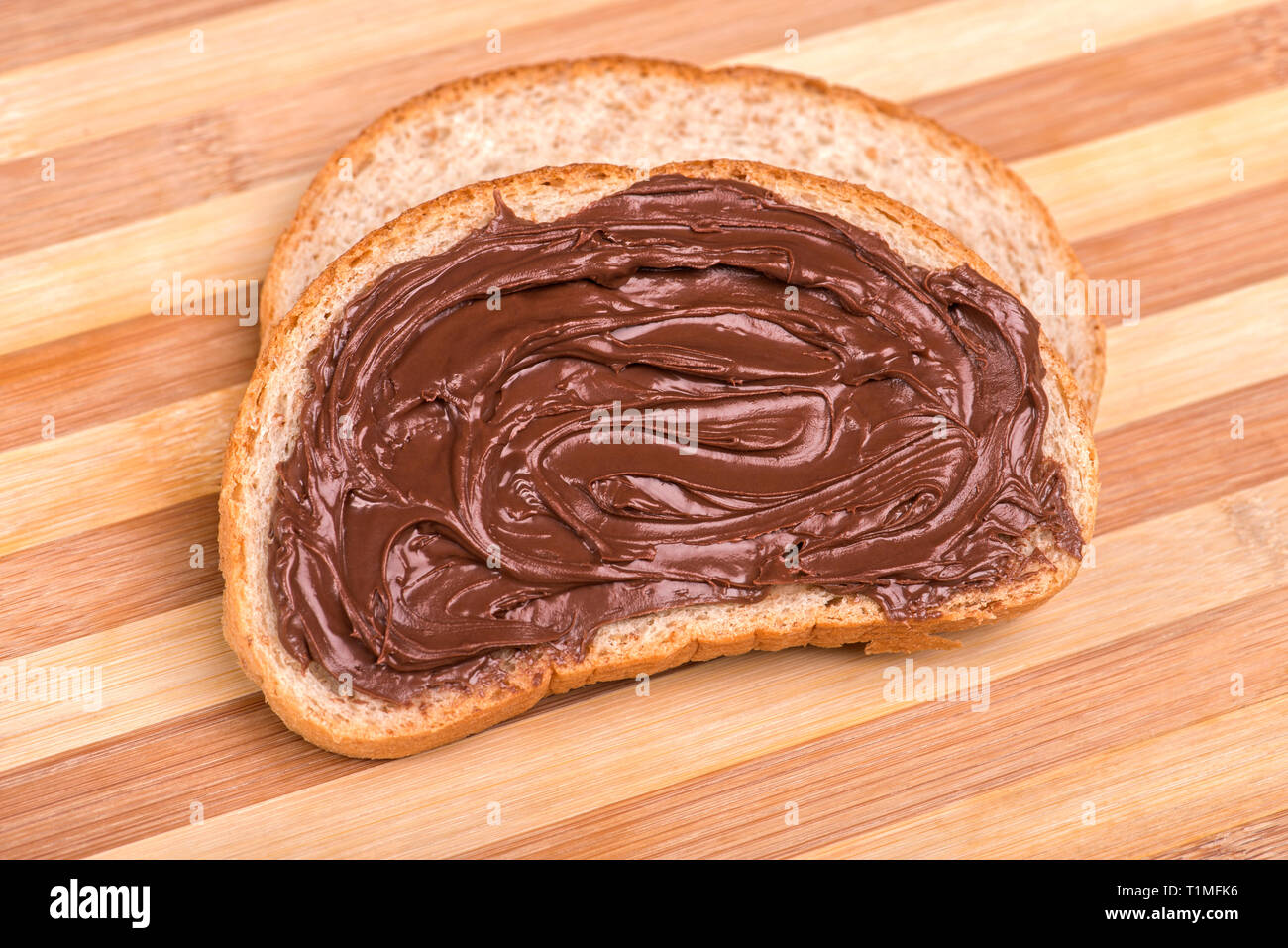 Fette di pane spalmato con cioccolato fuso Foto Stock