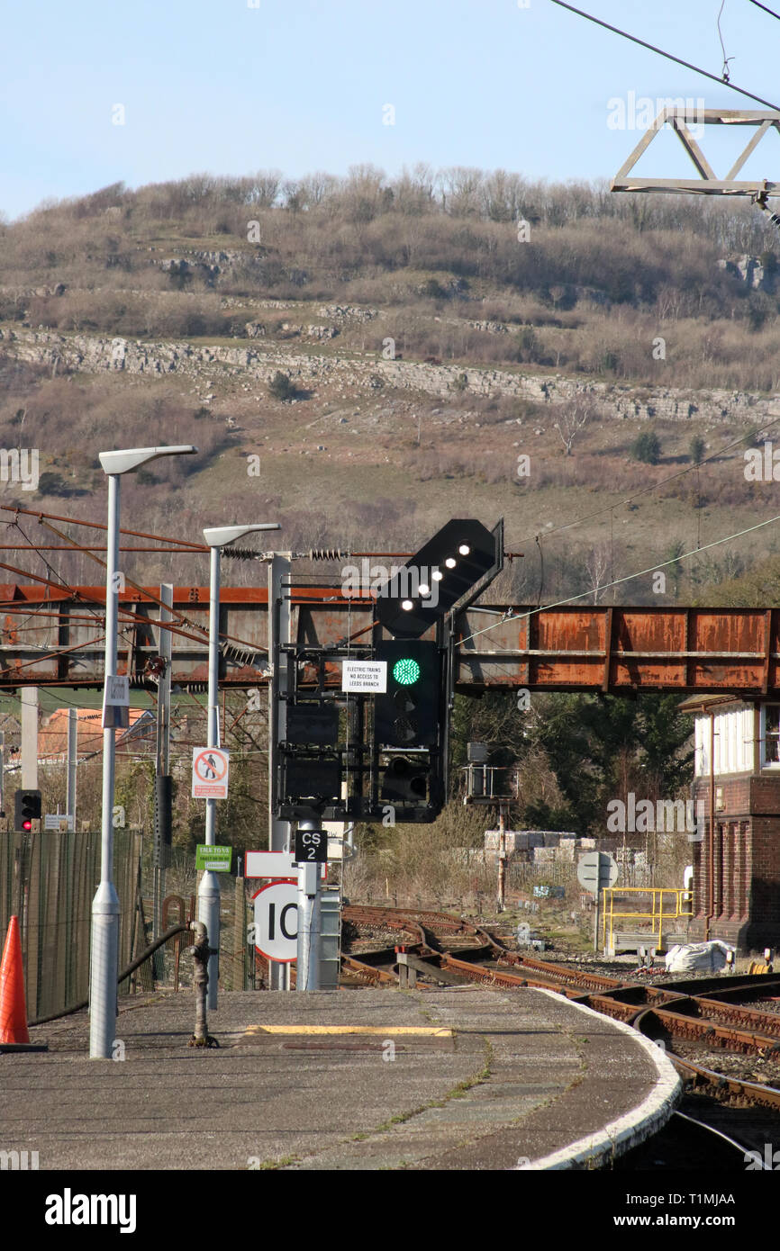 Feather indicatore di direzione nella parte superiore del segnale di colore alla fine della piattaforma 2 a Carnforth stazione ferroviaria che mostrano la direzione da prendere per il prossimo treno. Foto Stock
