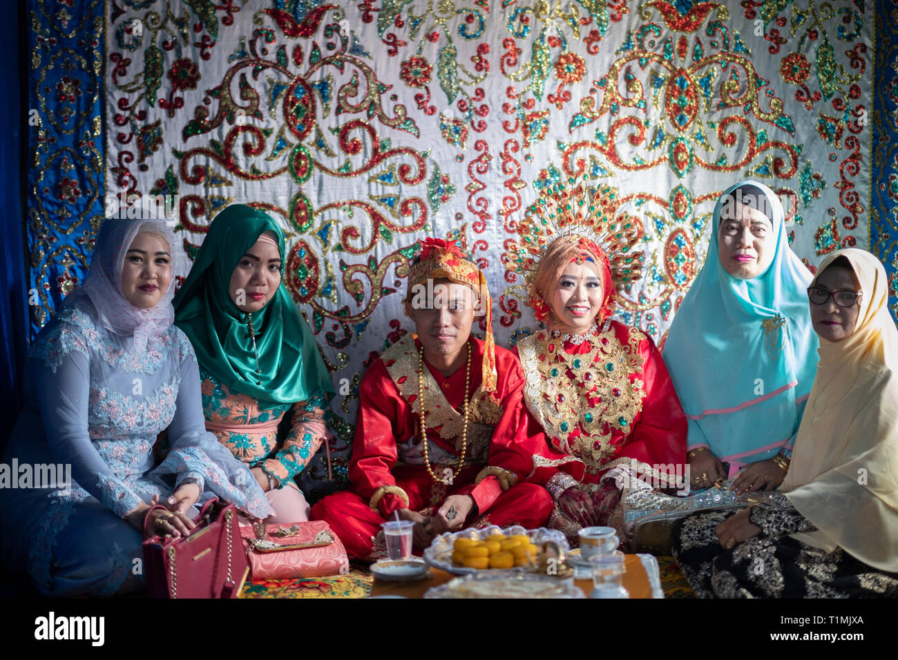 Gli sposi e i loro familiari a una festa di nozze, Sulawesi, Indonesia Foto Stock
