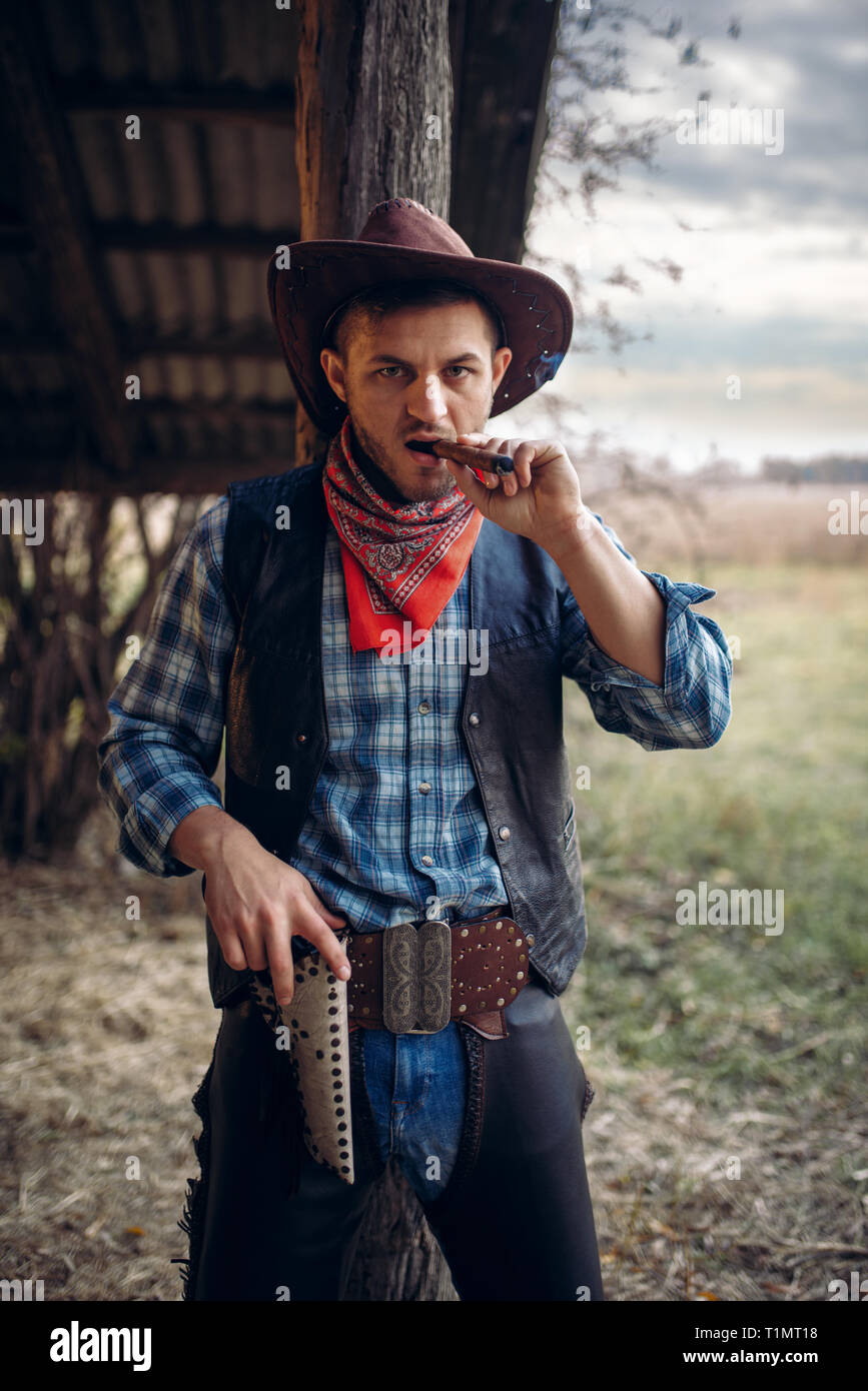 Brutale cowboy fuma un sigaro, wild west cultura Foto Stock