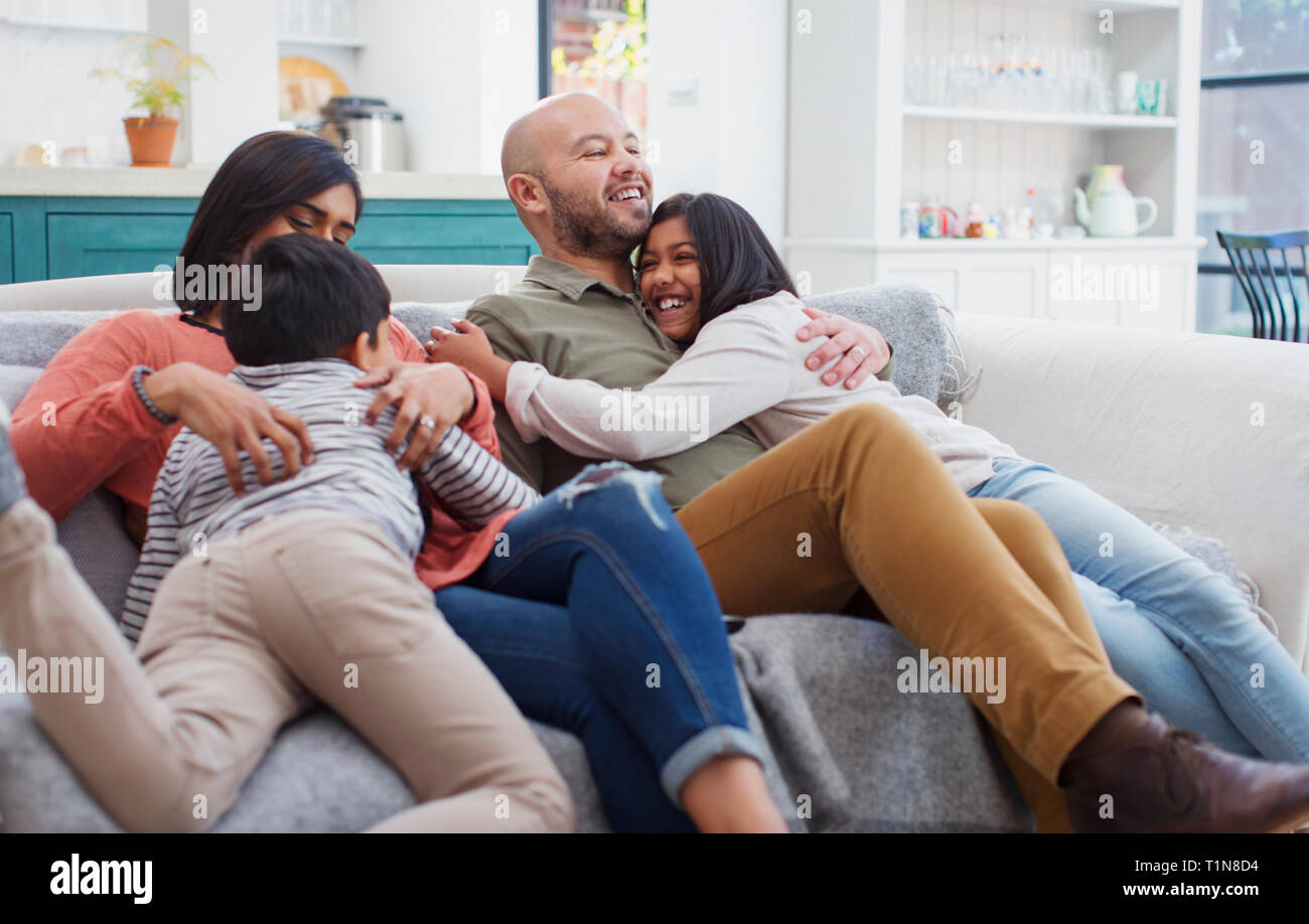 Felice, affettuosa famiglia sul divano Foto Stock