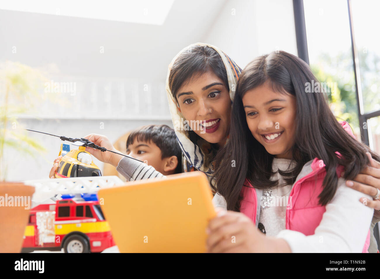 Felice madre e figlia con tavoletta digitale Foto Stock