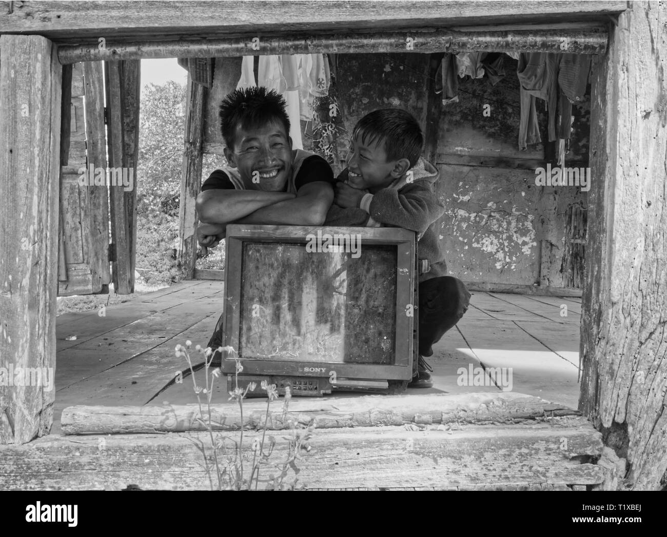 Fratelli di ridere dopo aver trovato il vecchio TV in una casa abbandonata Foto Stock