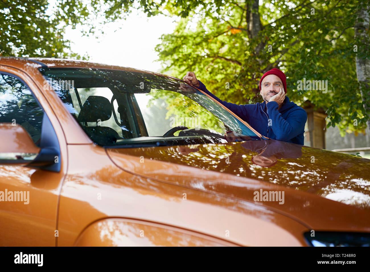 Uomo maturo poggiando su auto in natura Foto Stock