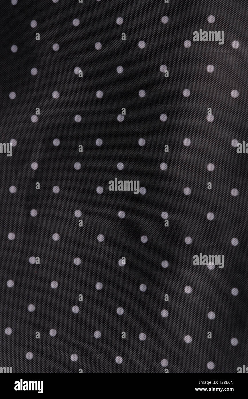 Tessuto nero lo sfondo con puntini bianchi Foto Stock