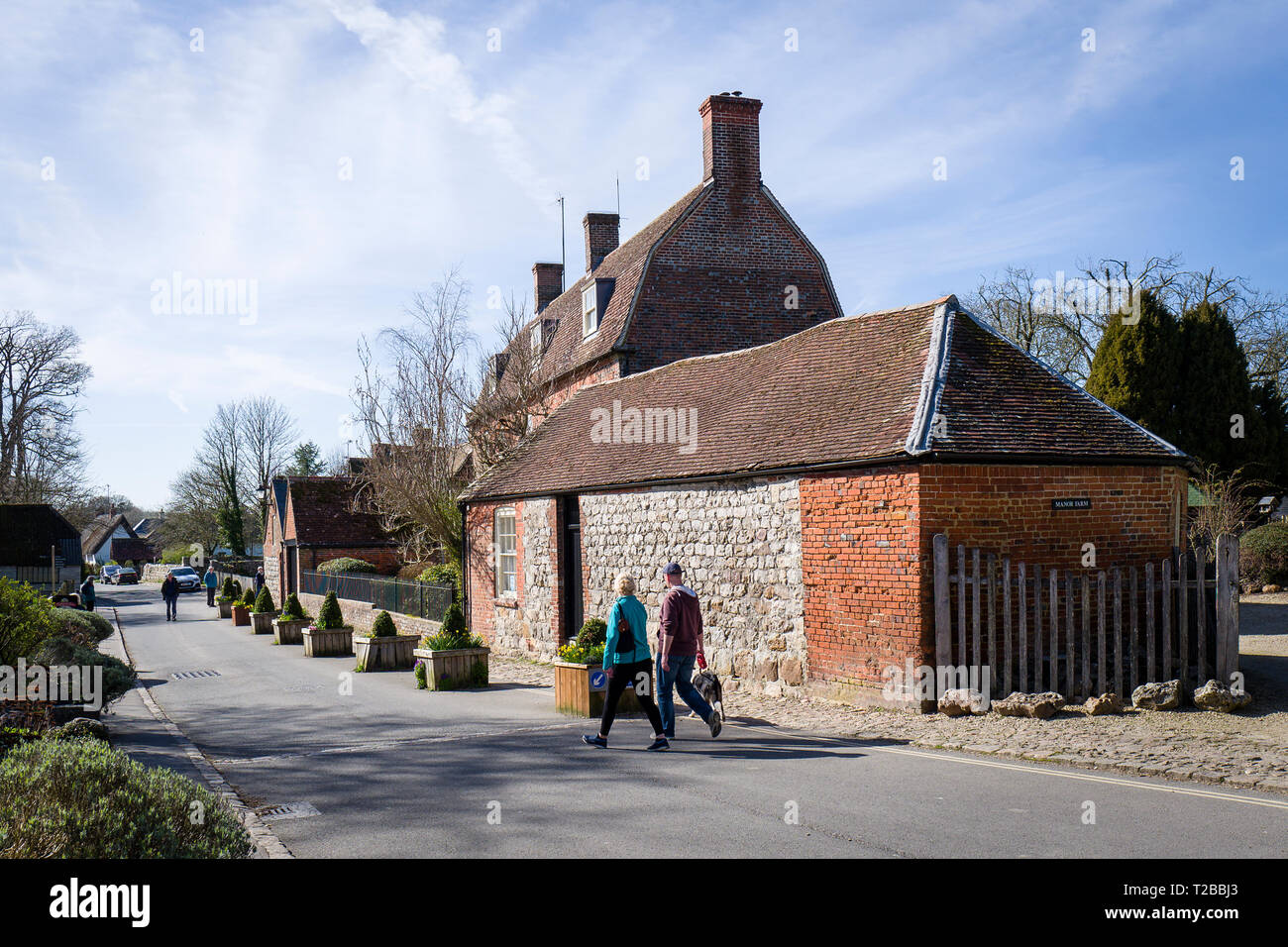 Il turista giovane esplorare Avebury Village nel Wiltshire, Inghilterra REGNO UNITO passando Manor Farm Foto Stock