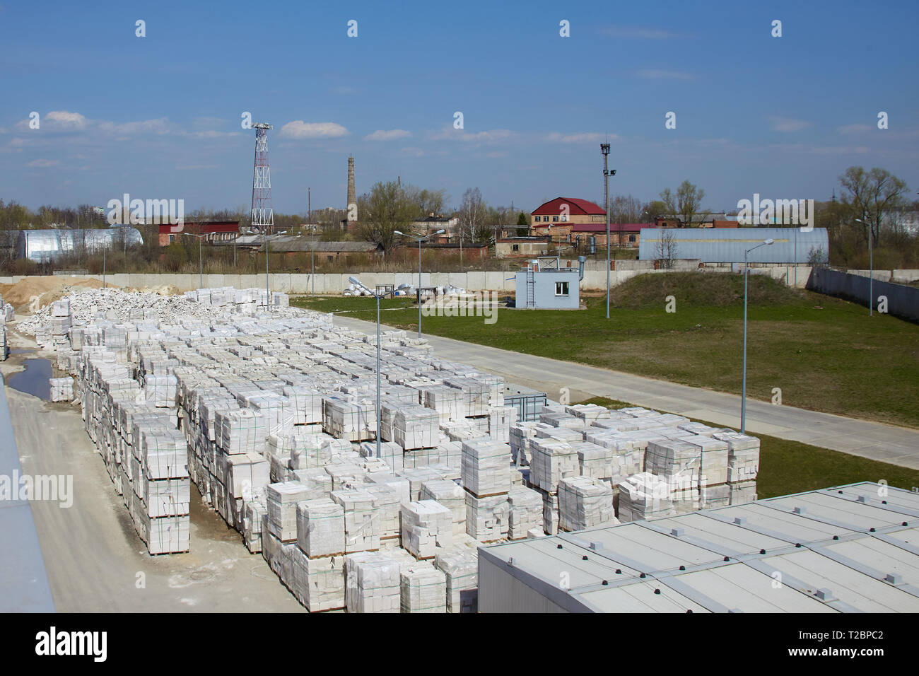 Vista della fabbrica di produzione di vegetali autoclavato calcestruzzo aerato. Molti pacchetti di blocchi su pallet mettere uno sull'altro in un magazzino esterno. Vista superiore Foto Stock
