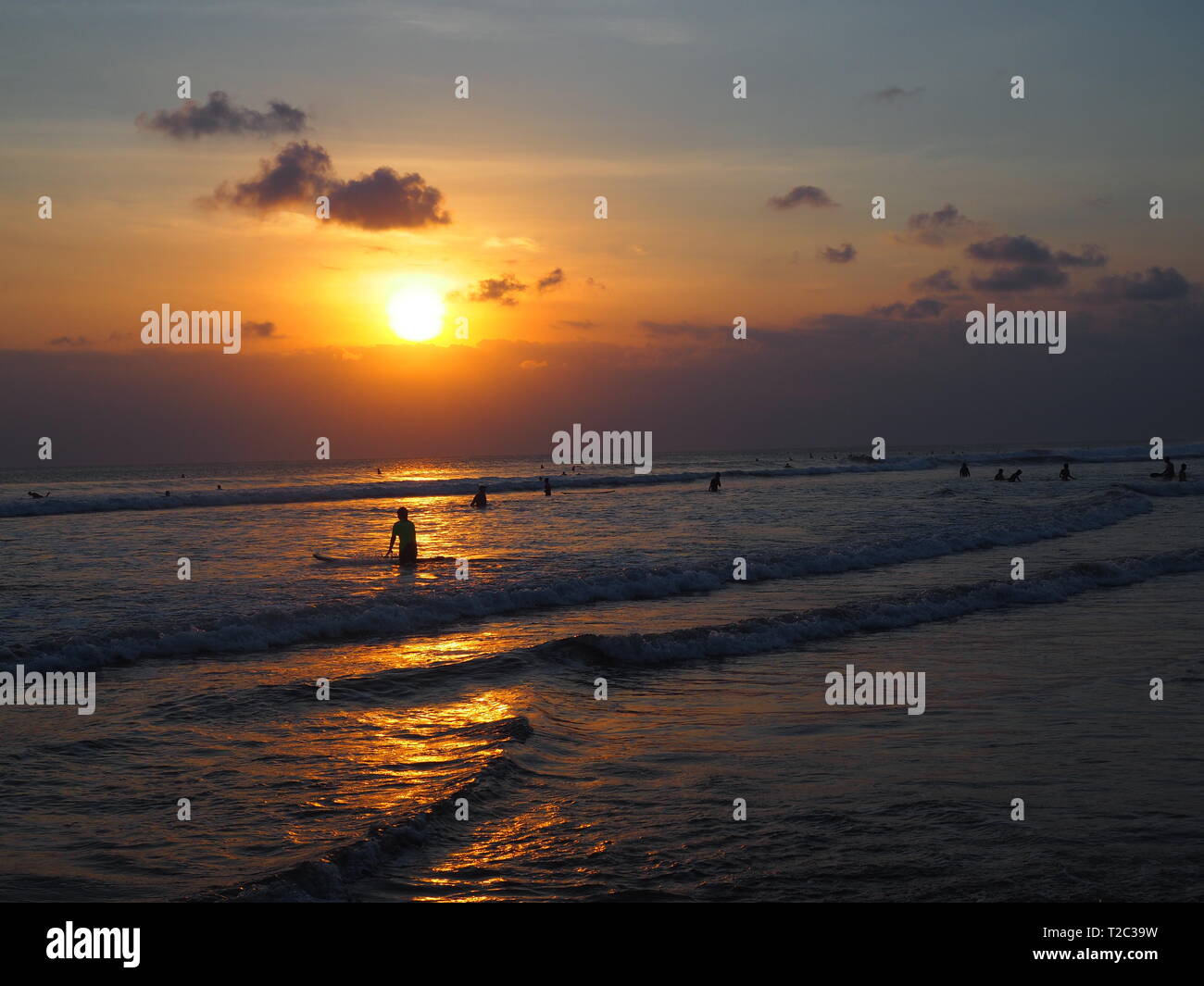 Il surf e il tramonto sulla spiaggia di Kuta Beach, Bali, Indonesia Foto Stock