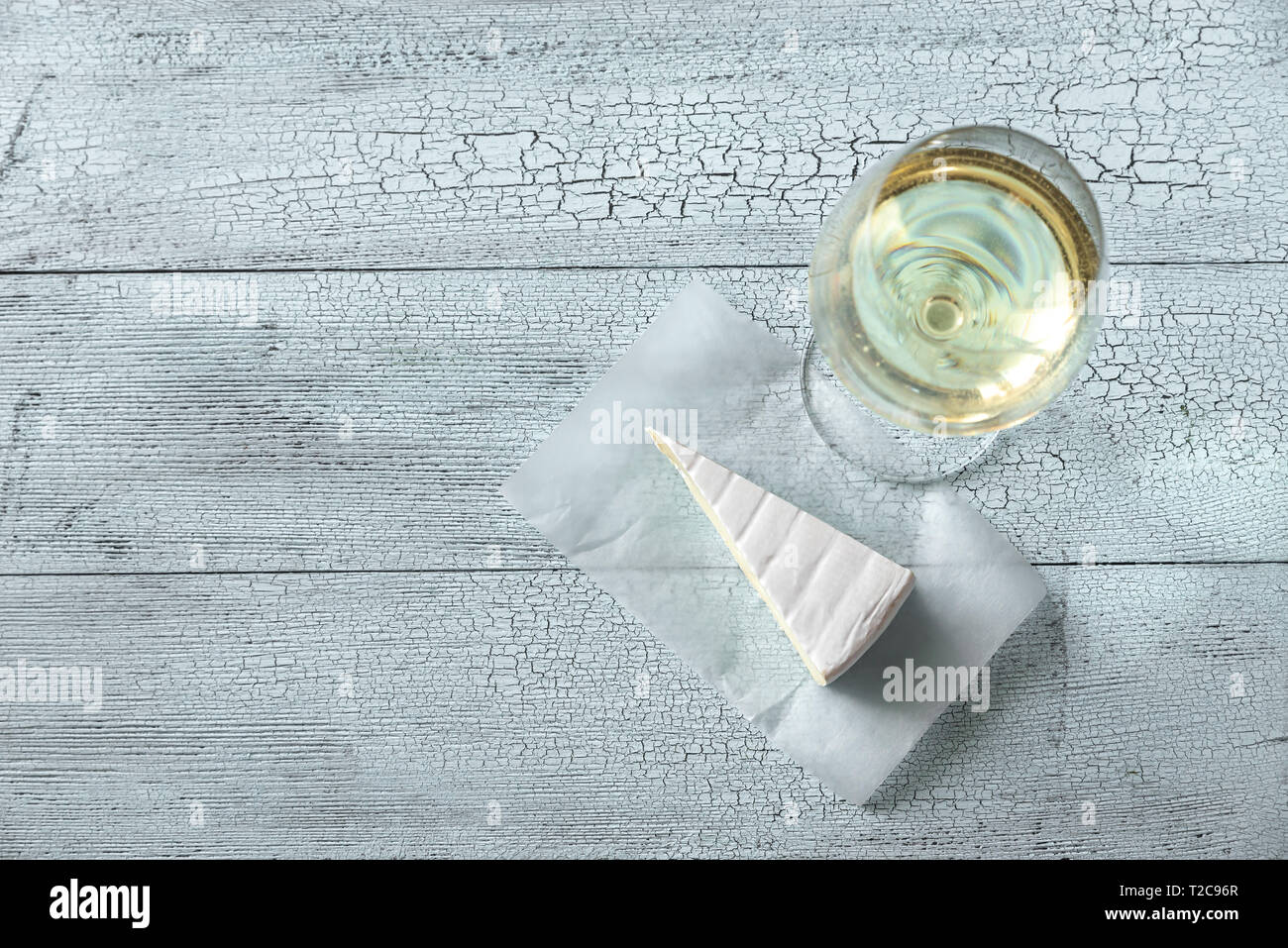 Bicchiere di vino bianco con Brie sullo sfondo di legno Foto Stock