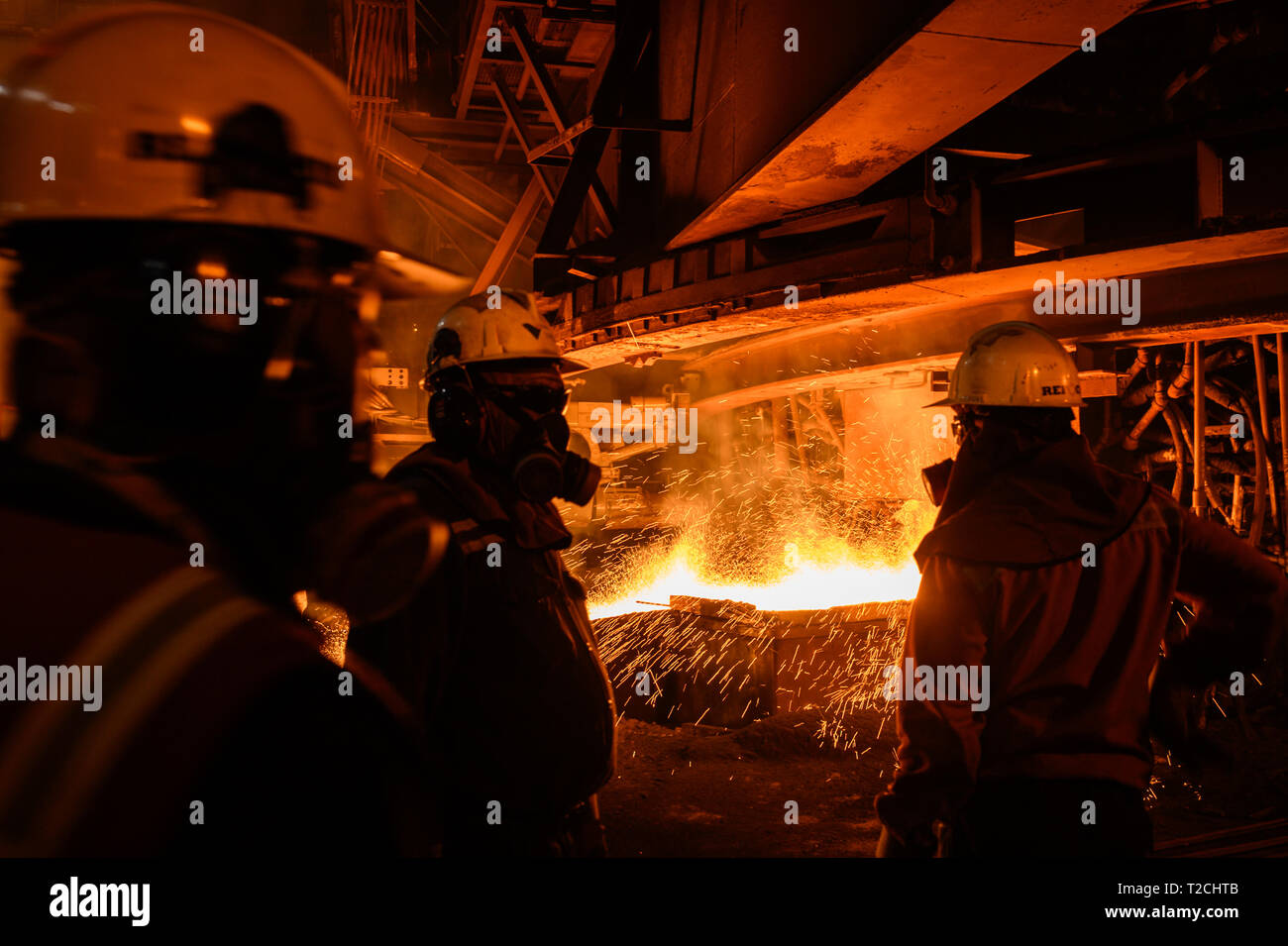 Marzo 30, 2019 - Sorowako, Sulawesi meridionale, Indonesia - Lavoratori visto con maschere antigas supervisionare il flusso di metallo liquido caldo come fluisce da un forno all'impianto..la produzione di nichel opaco al PT Vale il nichel impianto in Sorowako, Sulawesi meridionale, Indonesia, la pianta è il bersagliamento di una produzione di 75.000 tonnellate nel 2019. (Credito Immagine: © Hariandi Hafid/SOPA immagini via ZUMA filo) Foto Stock