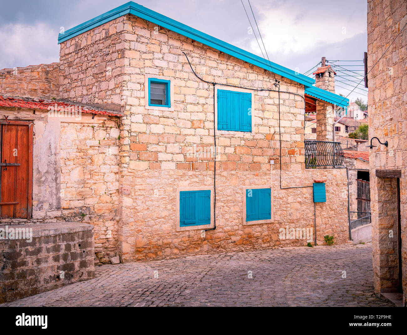 Vecchie case di pietra su strade strette nella pittoresca città medievale di Lofou. Distretto di Limassol, Cipro Foto Stock