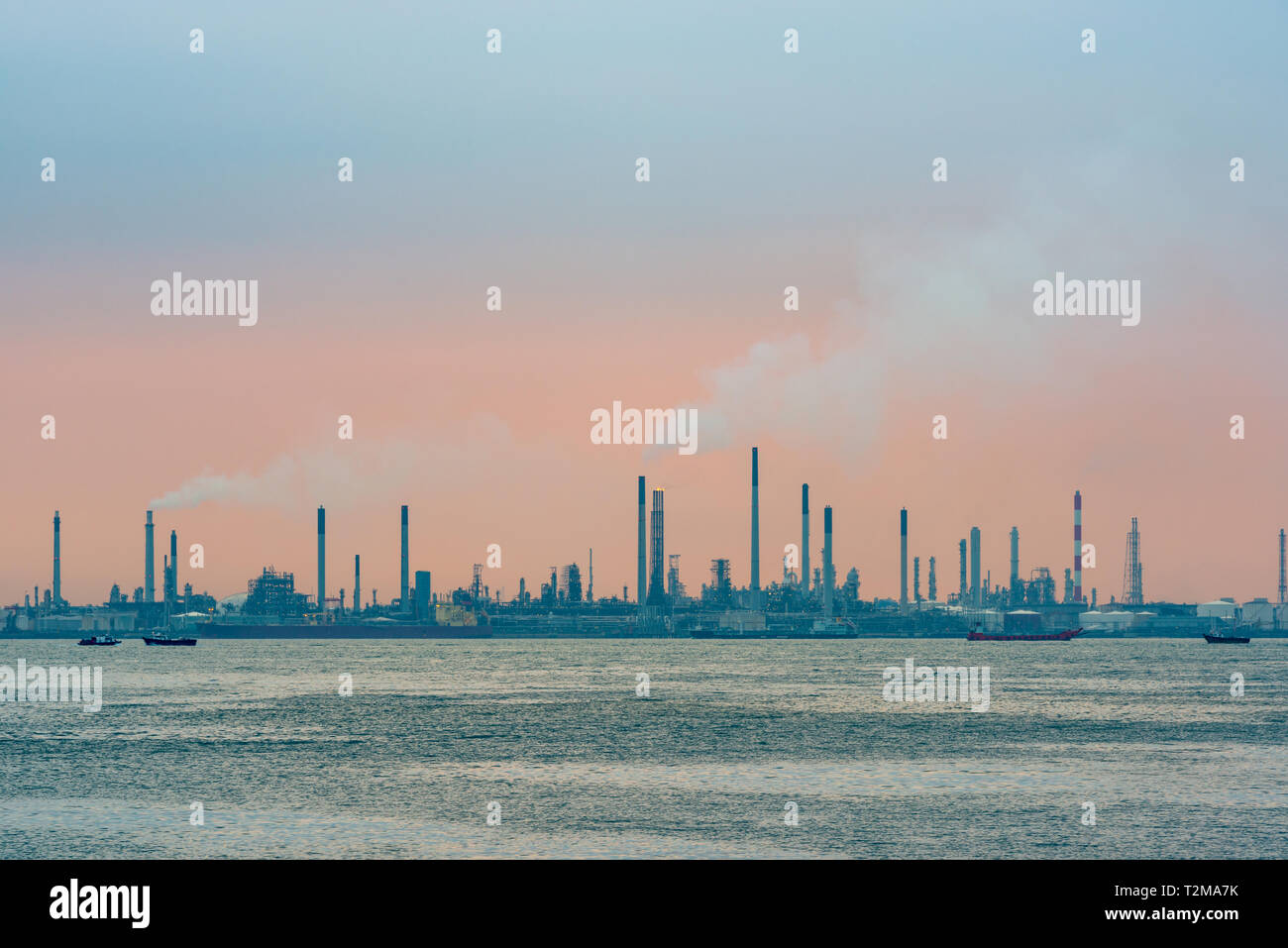 Raffineria di petrolio al tramonto su Bukom isola di Singapore Foto Stock