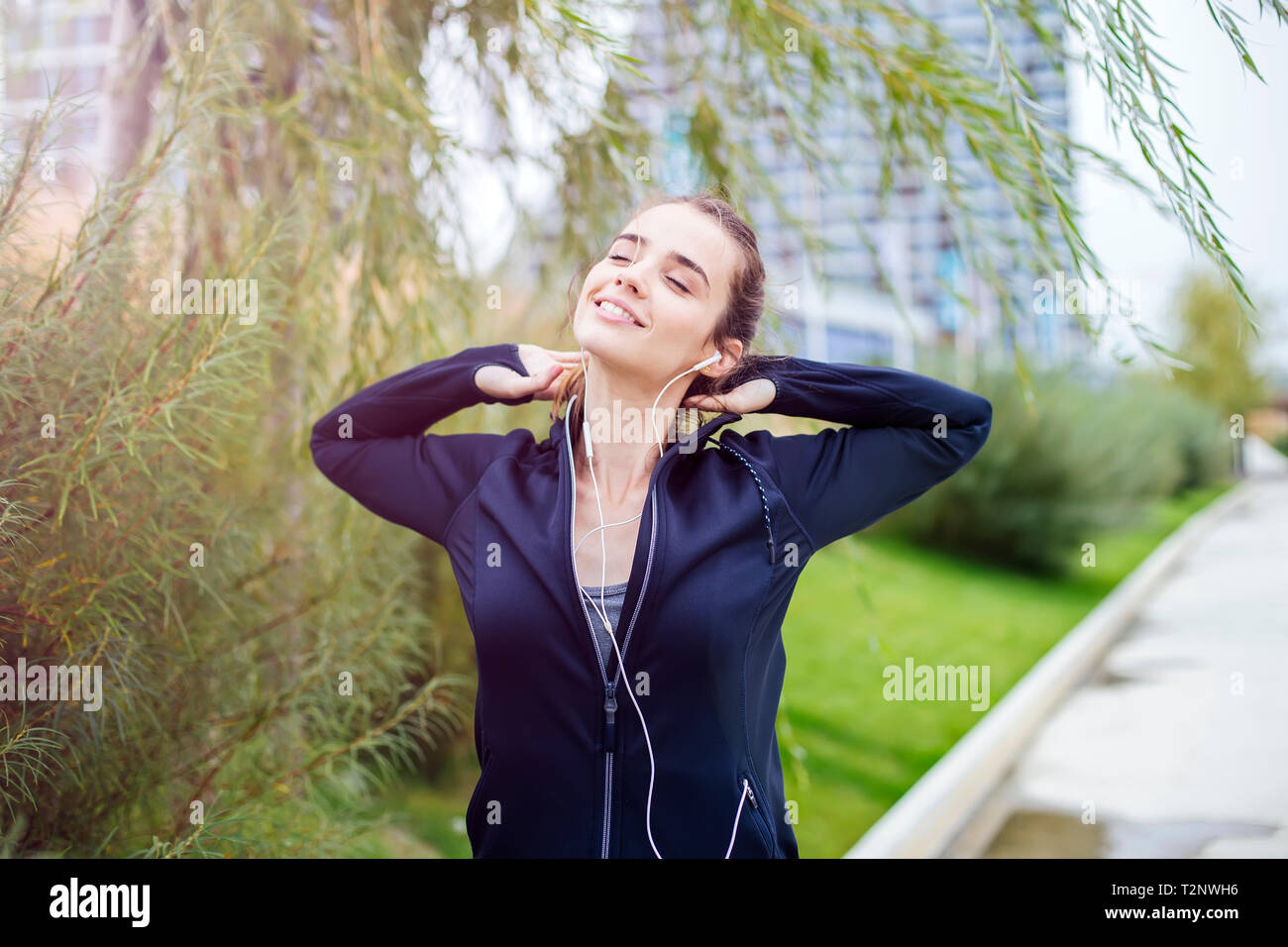 Ritratto di sportiva e attiva donna runner e ascolto di musica Foto Stock