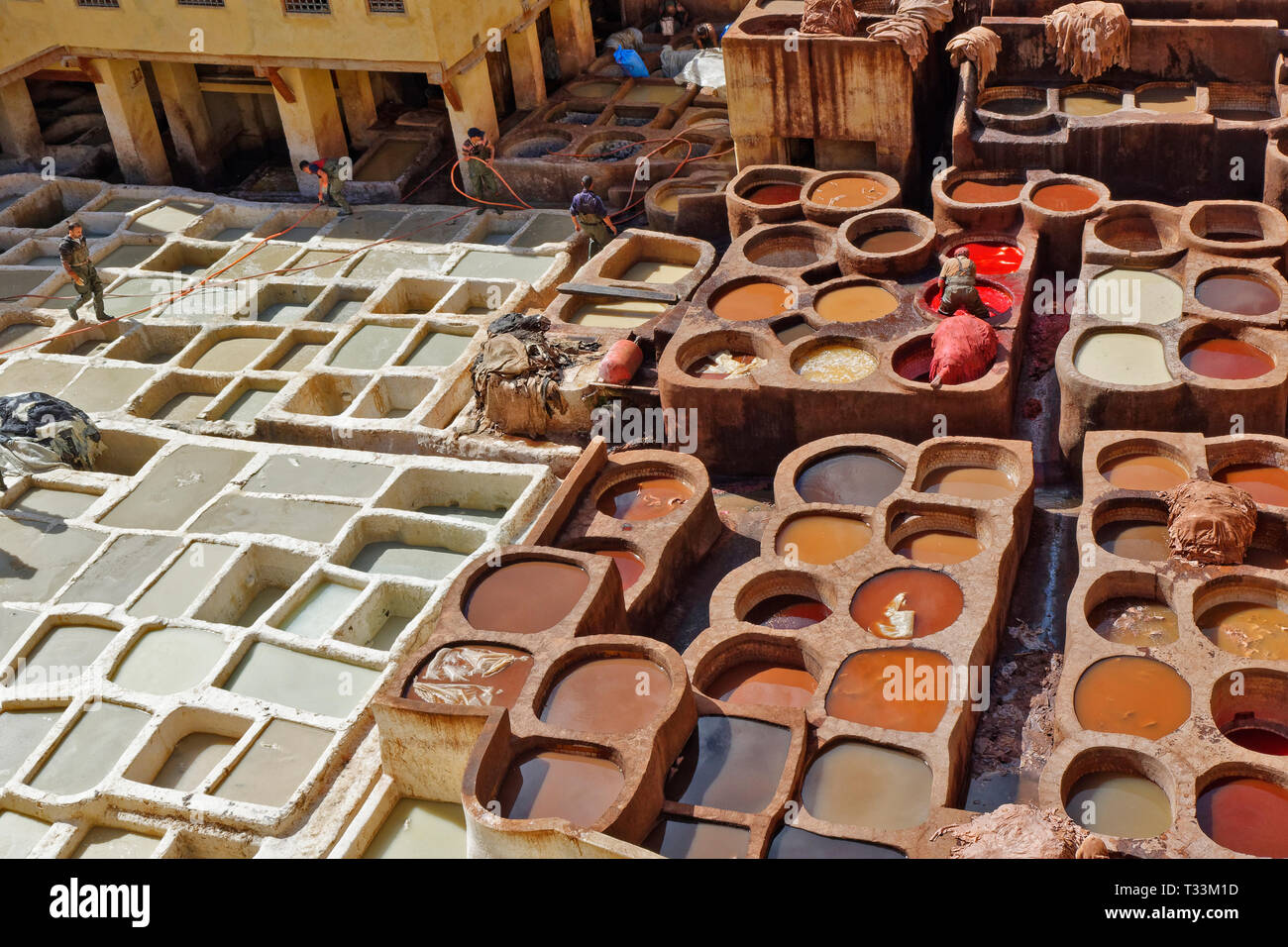 Il Marocco FES MEDINA CHOUARA CUOIO CONCERIA di lavoratori e vasche con pelli imbevuto di pigmenti colorati Foto Stock