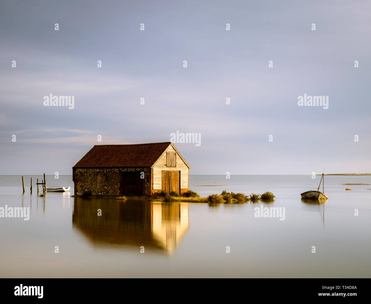 Il vecchio fienile di carbone a Thornham a marea alta. Foto Stock