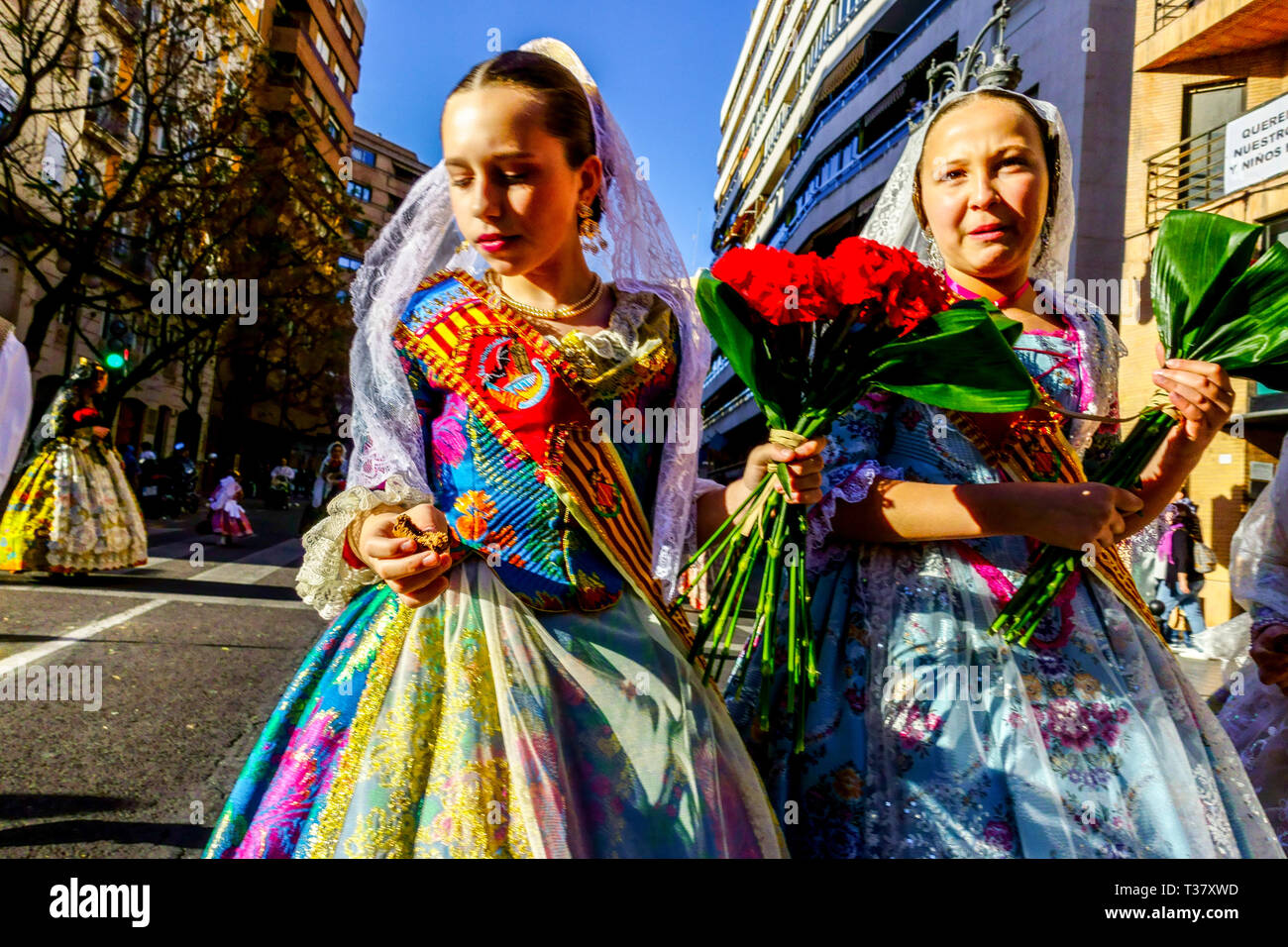 Las Fallas festival Valencia Donne gente in abito tradizionale costumi colorati marciando per la Virgen Spagna Foto Stock