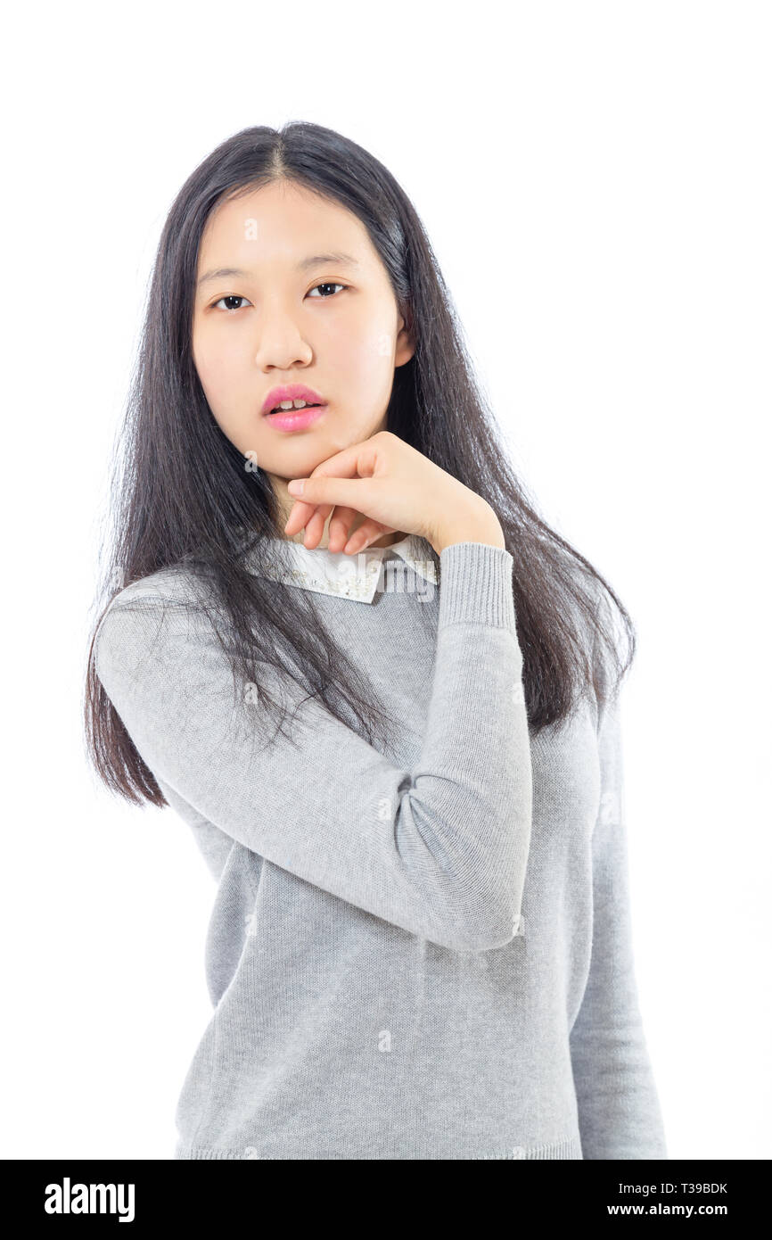 Teenage Asian high school girl con mento a portata di mano Foto Stock