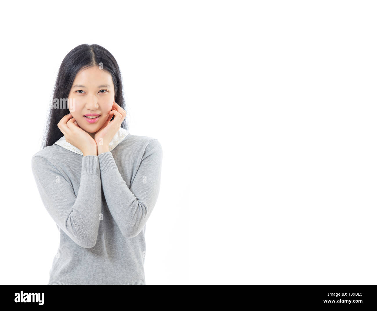 Teenage Asian high school girl con le mani sul mento Foto Stock