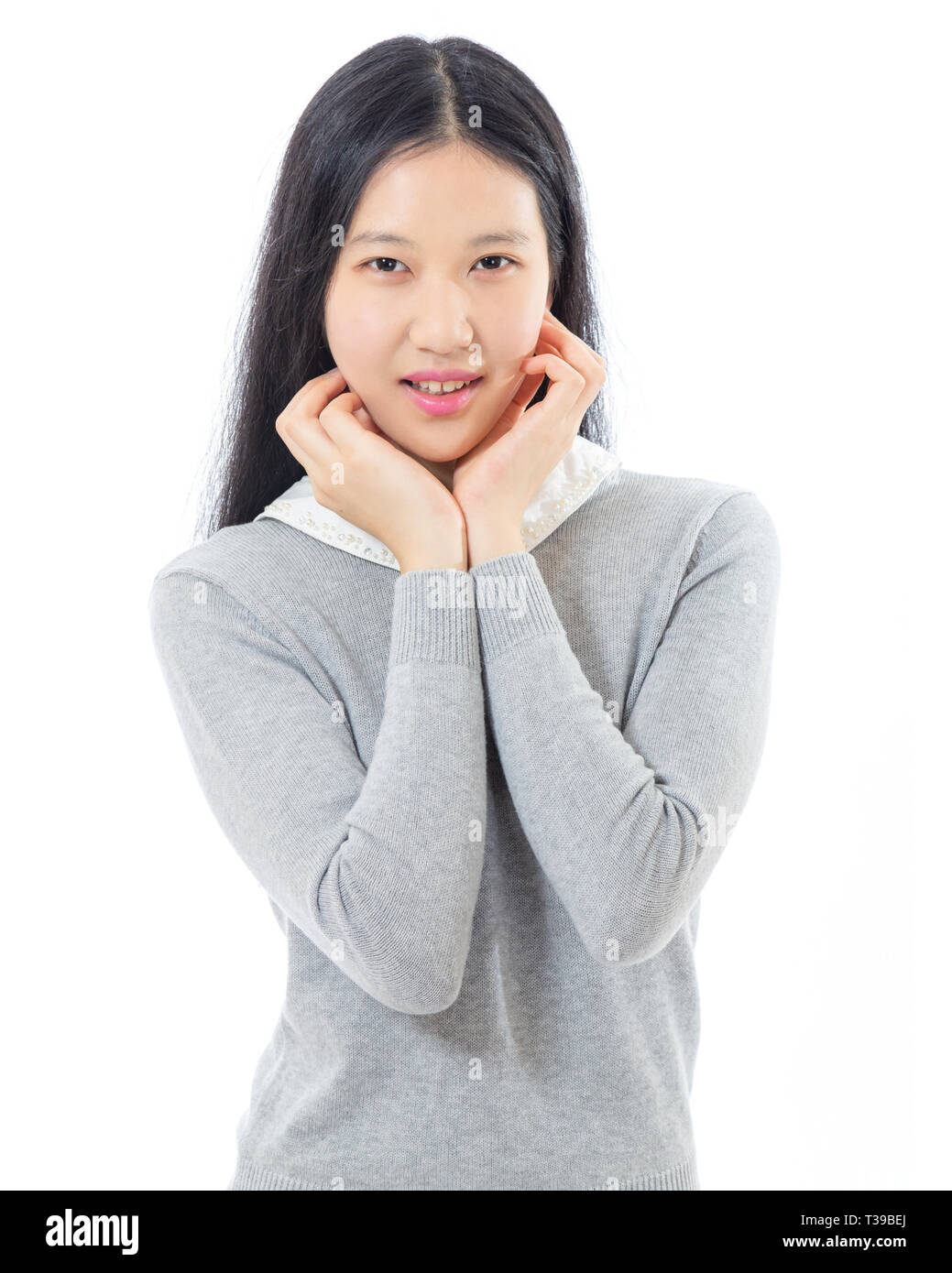 Teenage Asian high school girl, mani sul mento Foto Stock