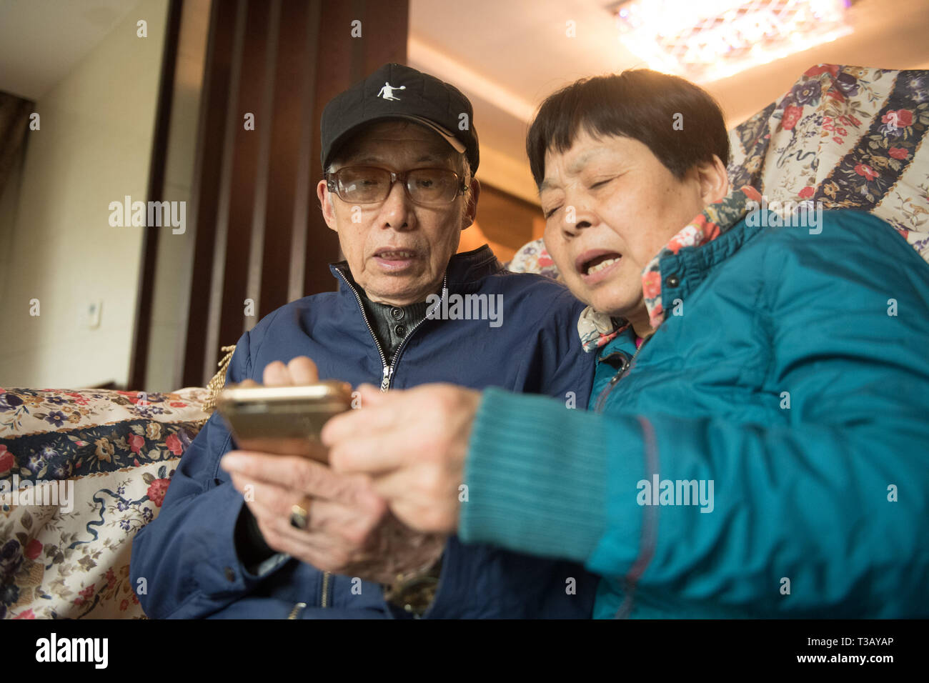(190408) -- HANGZHOU, 8 aprile 2019 (Xinhua) -- 80-anno-vecchio Zhu Ronglin(L) e 71-anno-vecchio Wang Hehua verificare le scorte sul cellulare foto a La Villa nel villaggio Gangdong di Yuhang distretto di Hangzhou, a est della Cina di Provincia dello Zhejiang, Marzo 29, 2019. Nel 2017, Zhu Ronglin ha avuto un idea di invitare alcuni anziani a vivere nella sua villa di modo che essi possono appendere fuori e si prendono cura di ogni altro. Egli ha rilasciato le informazioni sul quotidiano e di alcuni cittadini che erano interessati spostato alla sua villa dopo aver pagato per la loro base livings. Ora ci sono una decina di persone anziane che vivono nella sua villa e fanno th Foto Stock