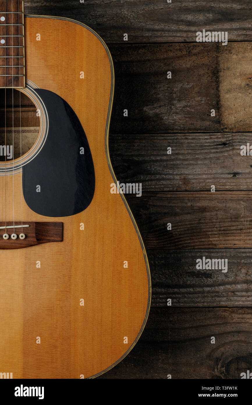 Chitarra acustica su grunge Sfondo legno da utilizzare come copertina per un corso di chitarra Foto Stock