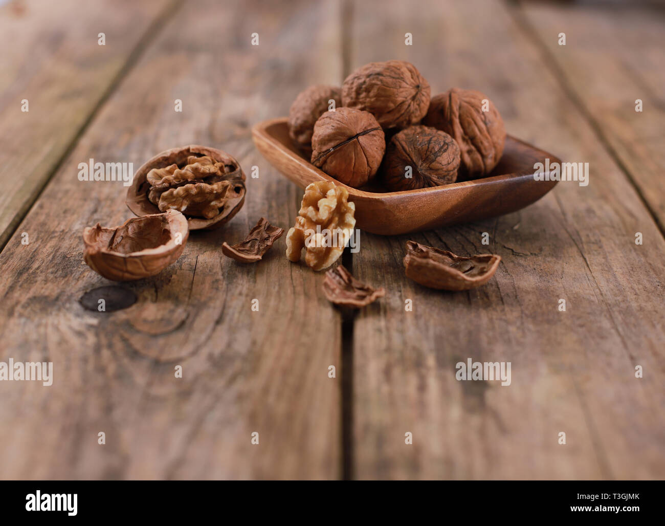 Noci su una tavola in legno rustico - close up - noci rotto e chiuso Foto Stock